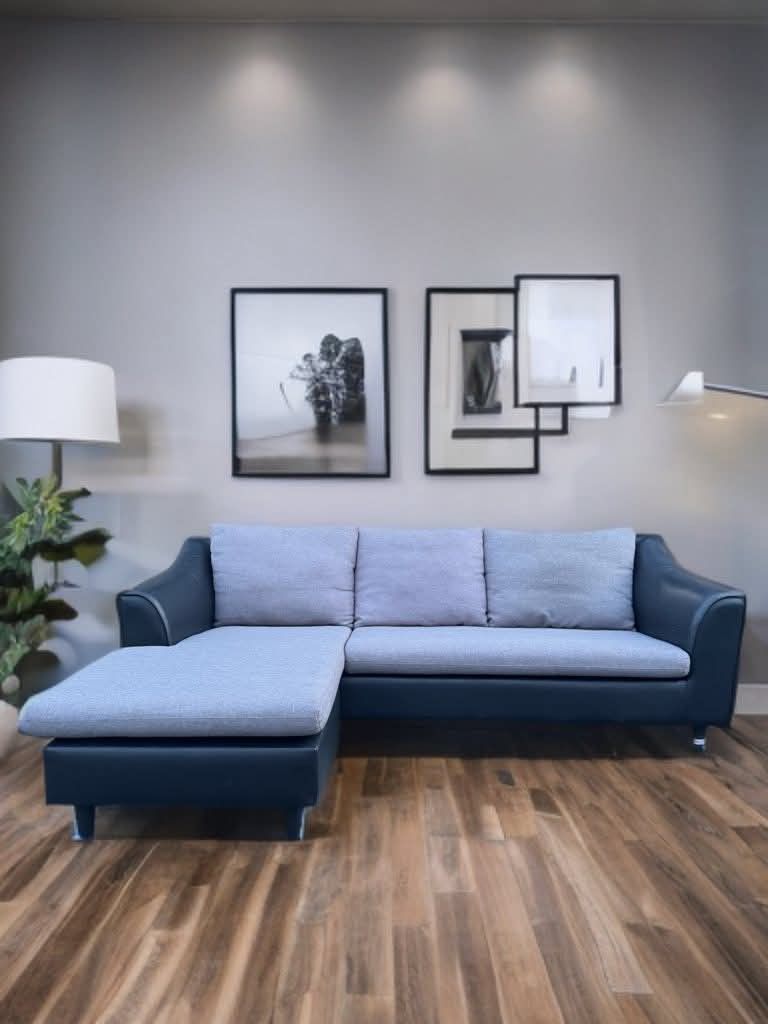 Sofa (Category: Sofas) located in Meycauayan. Submitted by marygracecasimiro (Listing ID 1419978802, Image 3). Description: 3-seater L-shaped couch sofa, often referred to as a chaise longue or corner sofa. It features a two-tone design combining a grey fabric seating area with a dark black base and frame, which is typically made of PVC leather or similar leather-fabric materials..