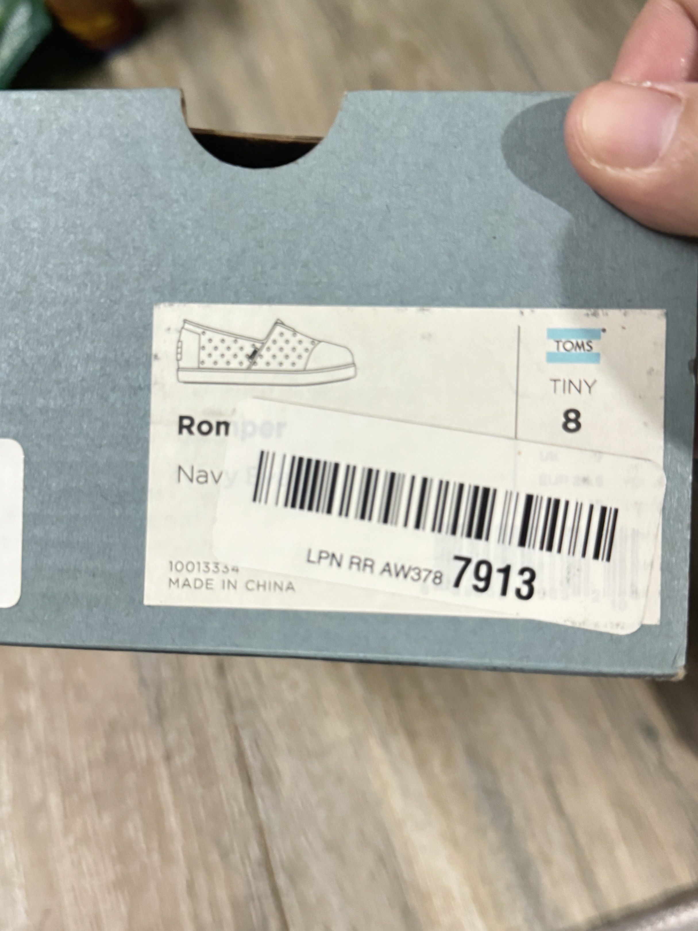 TOMS Romper Navy Shoes - Size 8 (Category: Babies & Kids Fashion) located in Pasig City. Submitted by mco2223 (Listing ID 1420018129, Image 3). Description: - TOMS Ronper shoes - Navy blue, size 8 - Slip-on style - Perforated design - White, textured soles - Includes original box - Made in China.