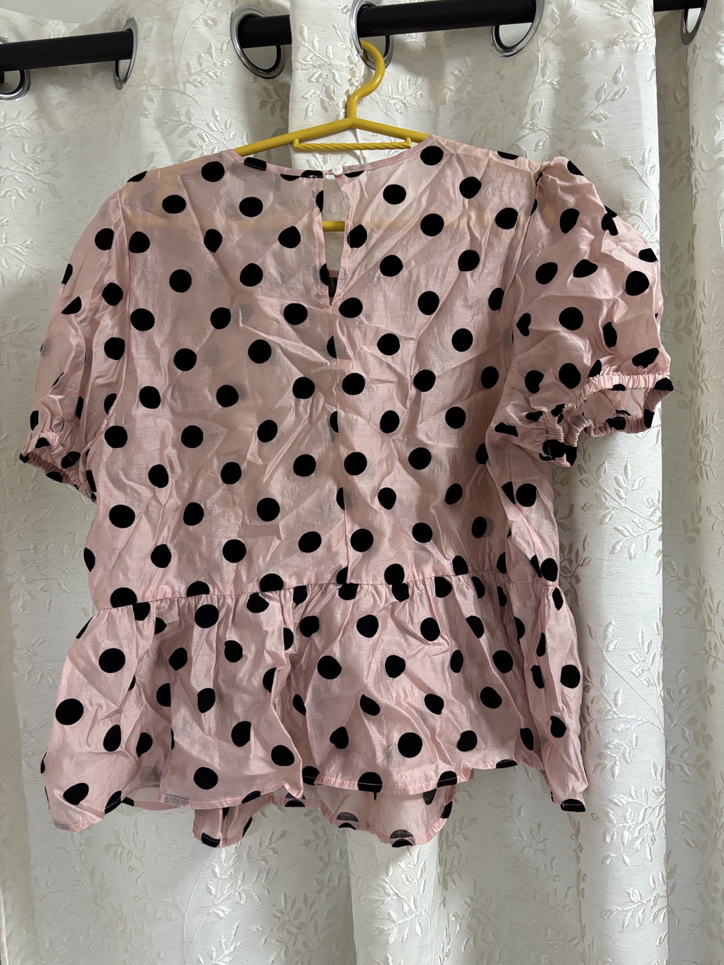 Urban Revivo Polka Dot Top (Category: Blouses) located in Pasig City. Submitted by eloisyy_declutter (Listing ID 1419984247, Image 3). Description: - Urban Revivo top - Pink base with black polka dots - Features short, puffed sleeves - Stylish peplum hem - Keyhole detail at the back - Size: M Never used.