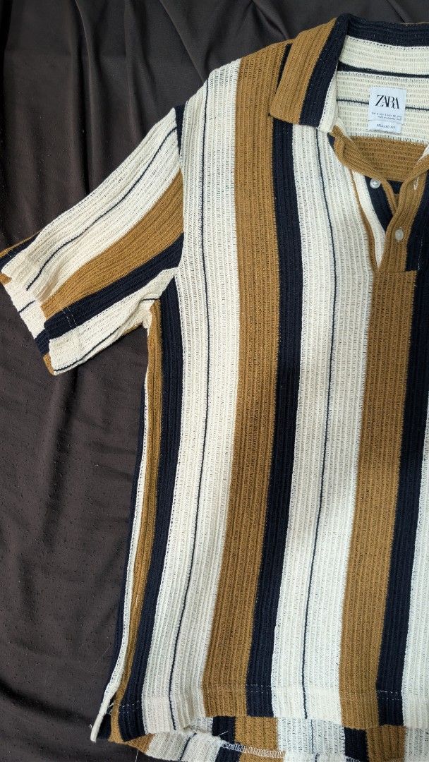 Zara Striped Polo Shirt (Category: Tshirts & Polo Shirts ) located in Makati City. Submitted by _mandalafinds (Listing ID 1420028559, Image 3). Description: - Zara polo shirt - Striped design - Collared neckline - Short sleeves - Chest pocket - Button-up placket - Textured knit fabric - Color scheme: White, navy, and brown stripes.