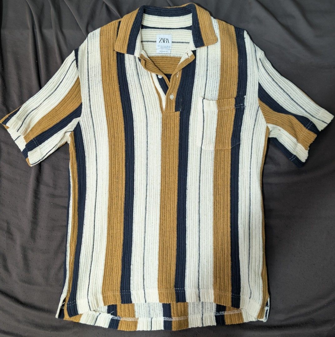 Zara Striped Polo Shirt (Category: Tshirts & Polo Shirts ) located in Makati City. Submitted by _mandalafinds (Listing ID 1420028559, Image 1). Description: - Zara polo shirt - Striped design - Collared neckline - Short sleeves - Chest pocket - Button-up placket - Textured knit fabric - Color scheme: White, navy, and brown stripes.