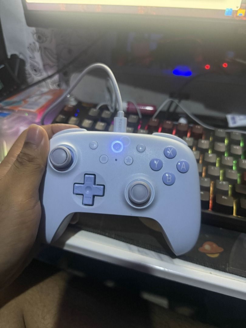 8BitDo Ultimate 2C Bluetooth Controller for Switch (Category: Controllers) located in Quezon City. Submitted by nees04 (Listing ID 1420301370, Image 2). Description: - 8BitDo Ultimate 2C Bluetooth Controller - Compatible with Switch - Stylish blue and pink design - Model: B0NC - Includes charging cable - Features D-pad, analog sticks, and buttons - "Walang Box" - No Issue may dent's lang kulay sa may analog and sa likod nya pero wpee naman linisa