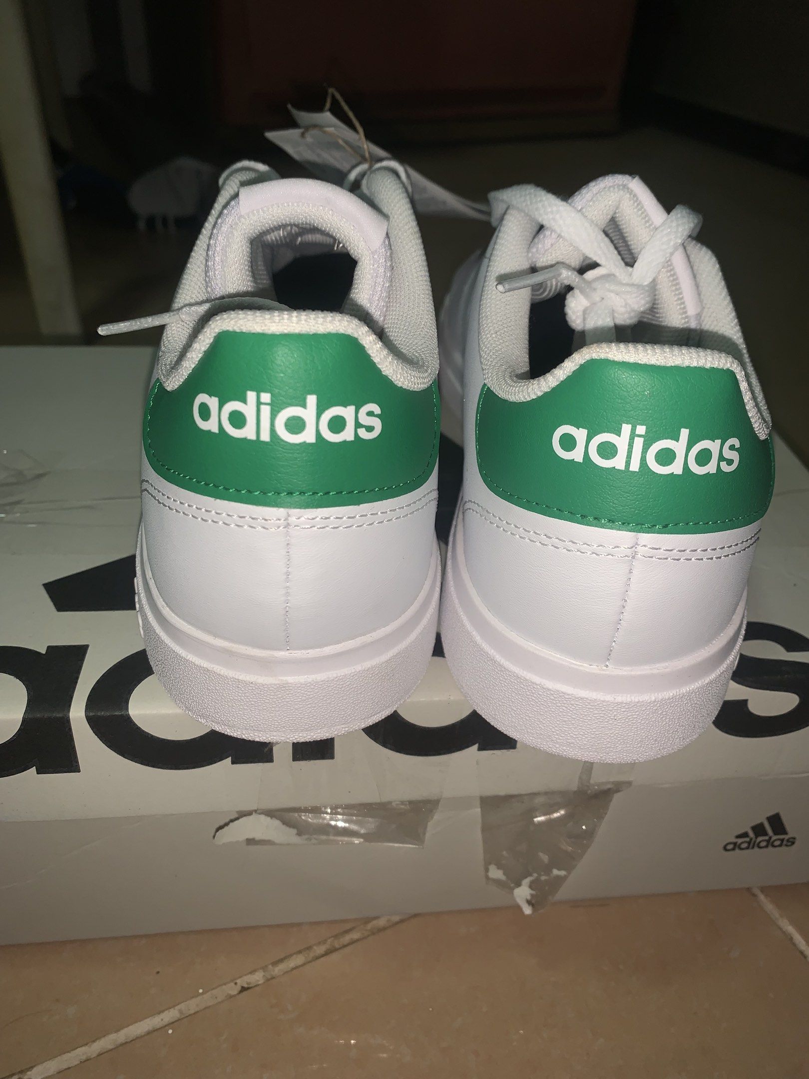 Adidas Advantage Base 2.0 White Green Sneakers (Category: Sneakers) located in Dagupan City. Submitted by luvskybear (Listing ID 1420284657, Image 2). Description: - Adidas Advantage Base 2.0 sneakers - White with green accents - Adidas logo on heel and tongue - Includes original box and tags - White sole - Lace-up closure - Size indicated on tag.