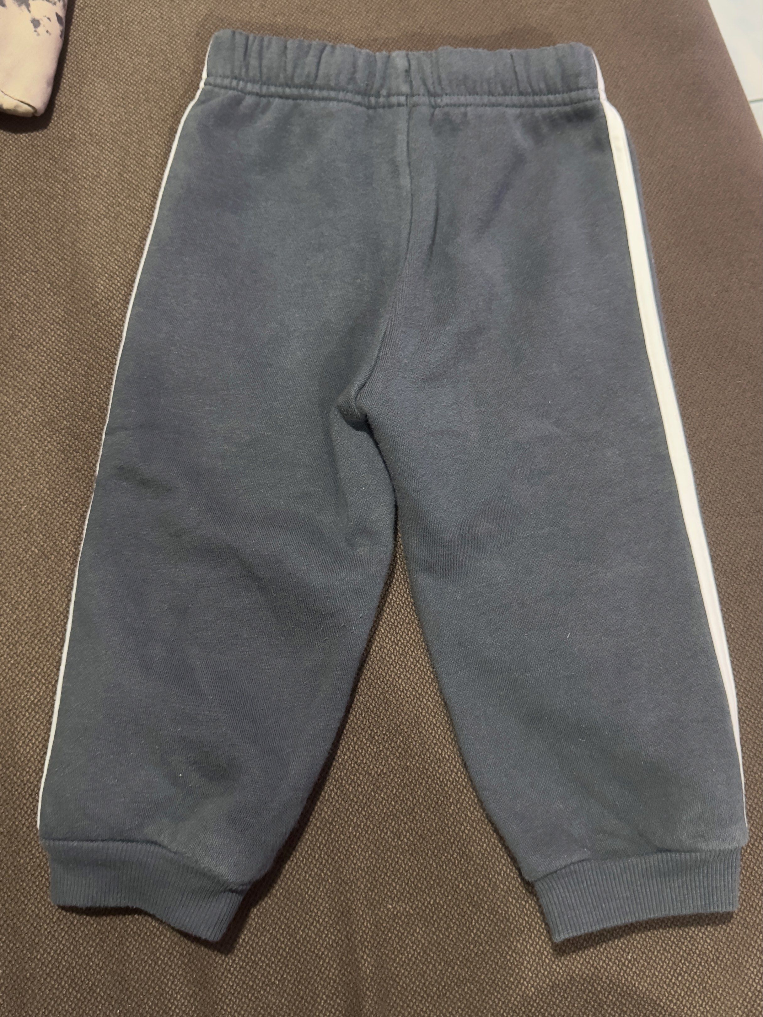 Adidas Toddler Track Pants Size 80 (Category: Babies & Kids Fashion) located in Angeles City. Submitted by gladnovic10 (Listing ID 1420321722, Image 3). Description: - Adidas Track Pants for Toddler - Color: Dark grey - Size: 80 - Features Adidas logo - With adjustable waist string - White stripes on sides - Made in Thailand - Material: 70% cotton, 30% polyester - Includes care label - Please manage your expectation. This is a preloved item..