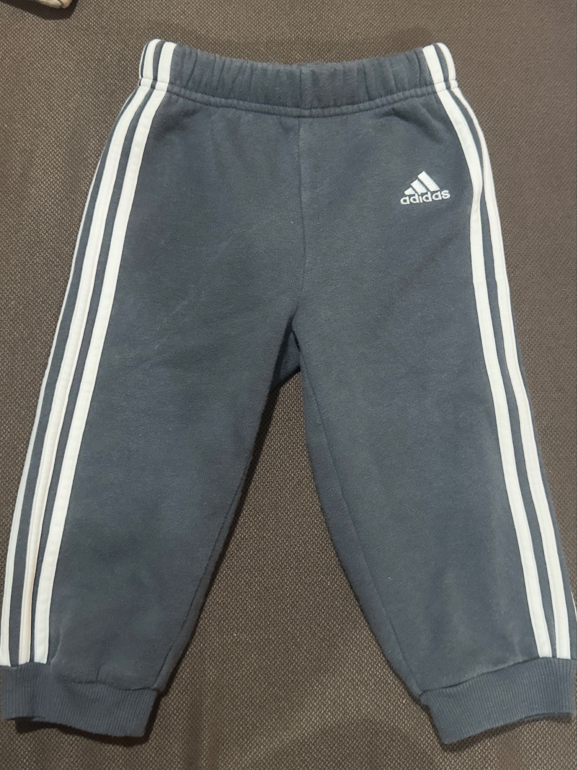 Adidas Toddler Track Pants Size 80 (Category: Babies & Kids Fashion) located in Angeles City. Submitted by gladnovic10 (Listing ID 1420321722, Image 1). Description: - Adidas Track Pants for Toddler - Color: Dark grey - Size: 80 - Features Adidas logo - With adjustable waist string - White stripes on sides - Made in Thailand - Material: 70% cotton, 30% polyester - Includes care label - Please manage your expectation. This is a preloved item..