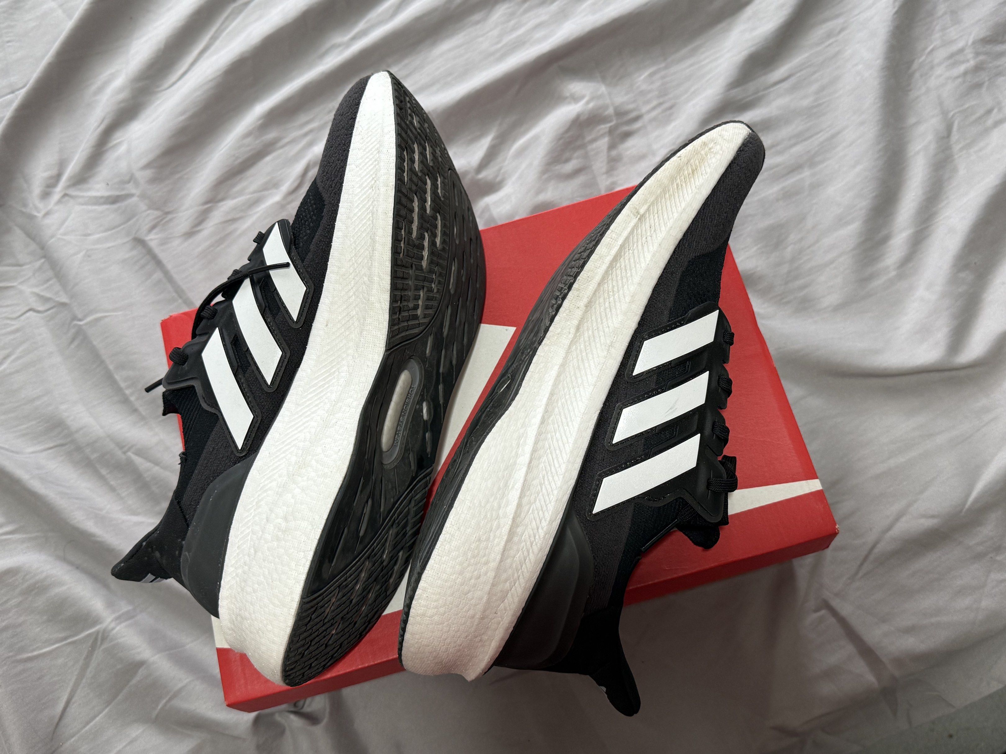 Adidas Ultraboost 22 Black White (Category: Sneakers) located in Pasig City. Submitted by louisyana (Listing ID 1420191408, Image 2). Description: - Adidas Ultraboost - Black and white colorway -used thrice - US size 11.5, UK size 11, EUR size 46 - alternate box only Mandaluyong area.