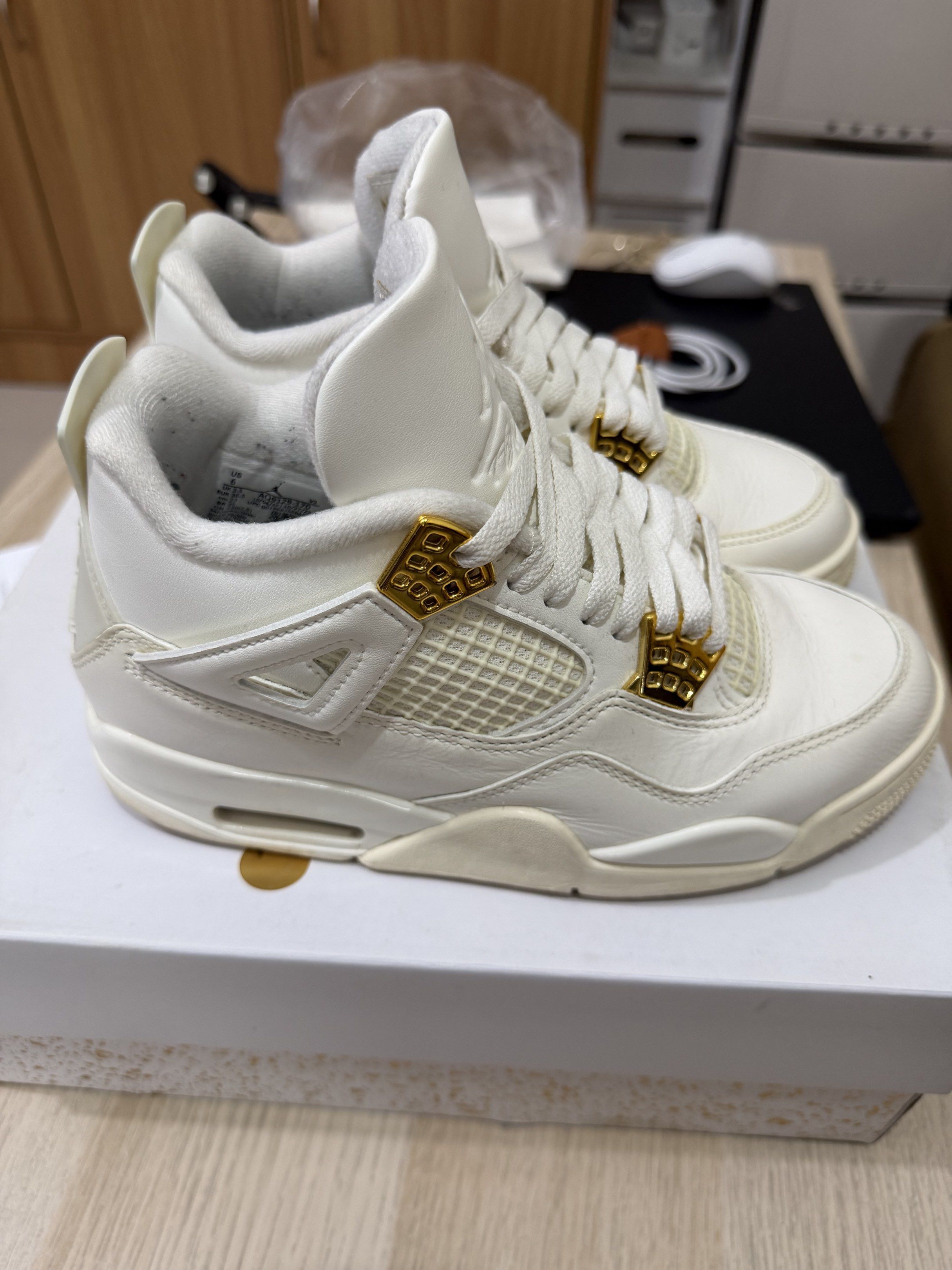 Air Jordan 4 Retro Sail Metallic Gold (Category: Sneakers) located in Taguig. Submitted by mavif (Listing ID 1420248331, Image 2). Description: - Air Jordan 4 Retro - Colorway: Sail/Metallic Gold - White leather upper with gold accents - Size: 6 US (wmns) - Includes original box.