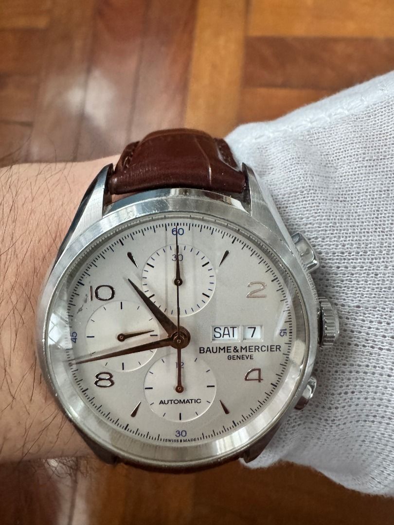 Baume & Mercier Clifton Chronograph Automatic Watch 41mm (Model Reference No. MOA10054) (Category: Luxury Watches) located in Makati City. Submitted by rafa_encarnacion (Listing ID 1420205724, Image 2). Description: - Baume & Mercier Clifton automatic movement chronograph watch - 41mm - Model Reference No. MOA10054 - Case/Serial No. 5582546 - Off-White/Silver dial with sub-dials - Rose gold-tone numerals and hands - Stainless steel case - Day/dat