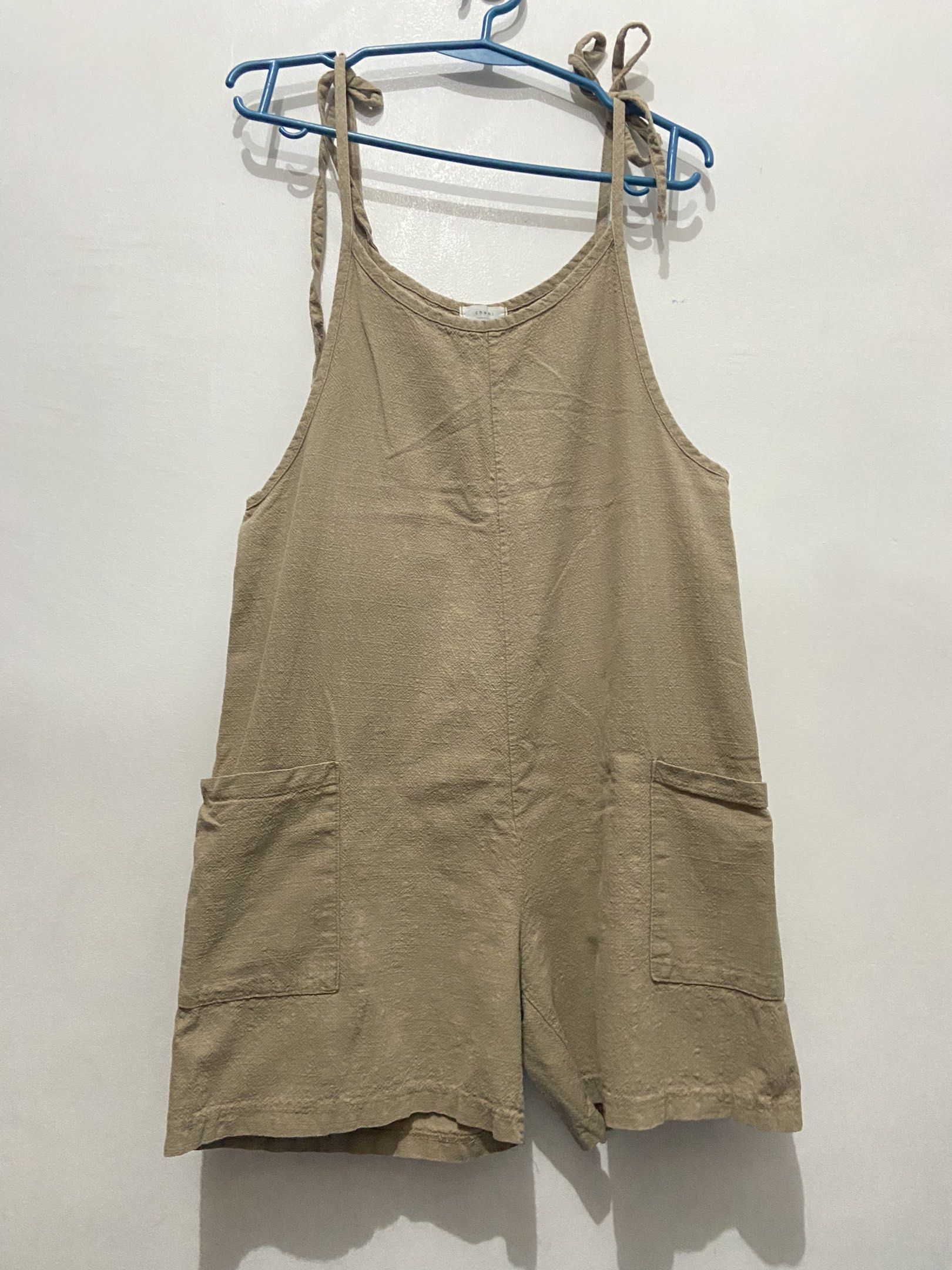 Beige Romper Overalls (Category: Jumpsuits) located in Pasay City. Submitted by trixietrix (Listing ID 1420259666, Image 1). Description: - Beige romper overalls - Adjustable tie straps - Two front pockets - Relaxed fit - Textured fabric - Oversized for petite/small frame, loose-fit on medium frame.