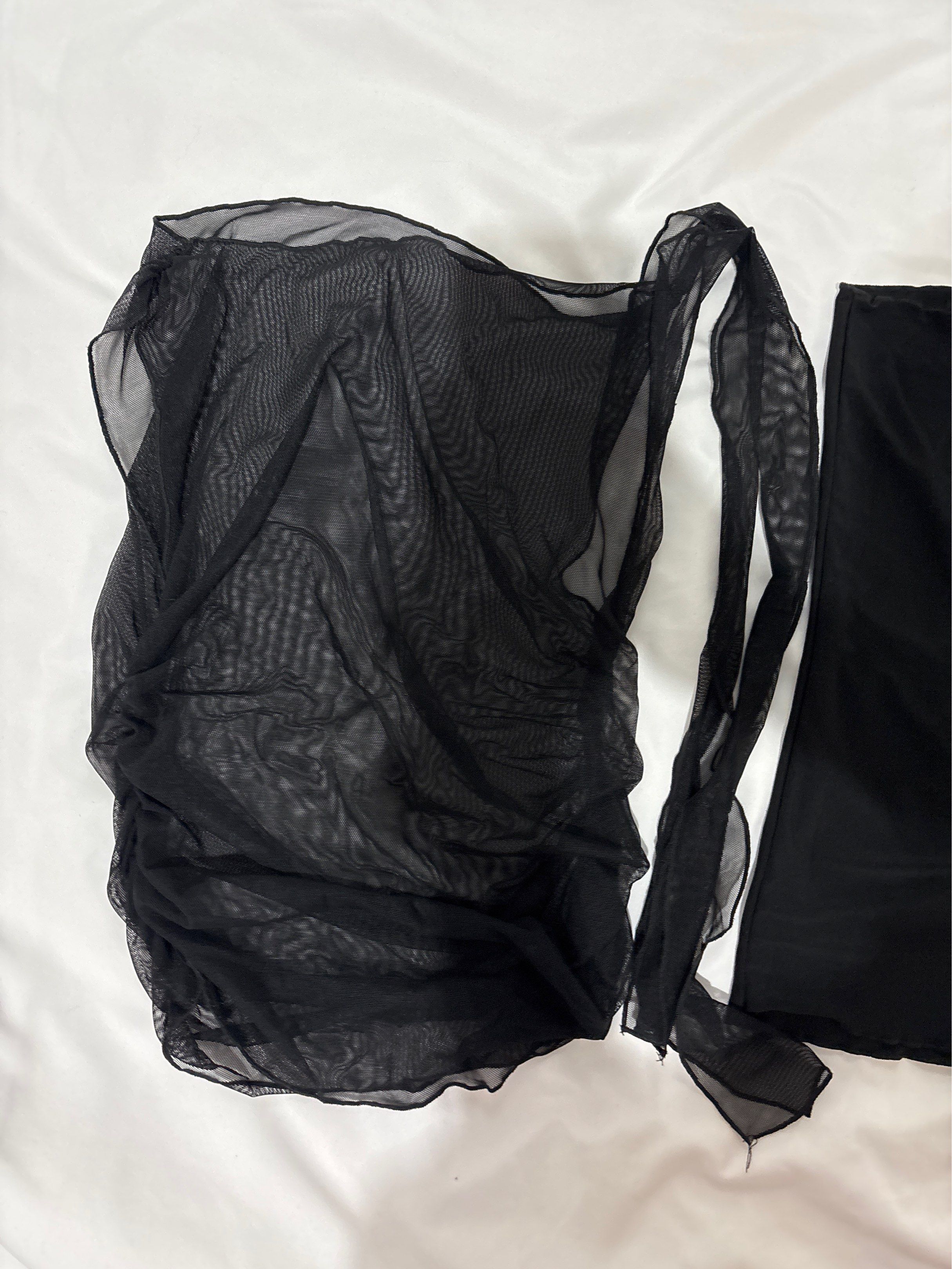 Black Mesh Tube Tie Top (Category: Dresses) located in Mandaluyong City. Submitted by castpreloveds (Listing ID 1420255659, Image 2). Description: - USED ONLY TWICE - Black mesh tie top & black tube - Ruched front detail - Flowing, sheer overlay - Sleeveless design - Includes separate tie fabric - Delicate, see-through fabric.