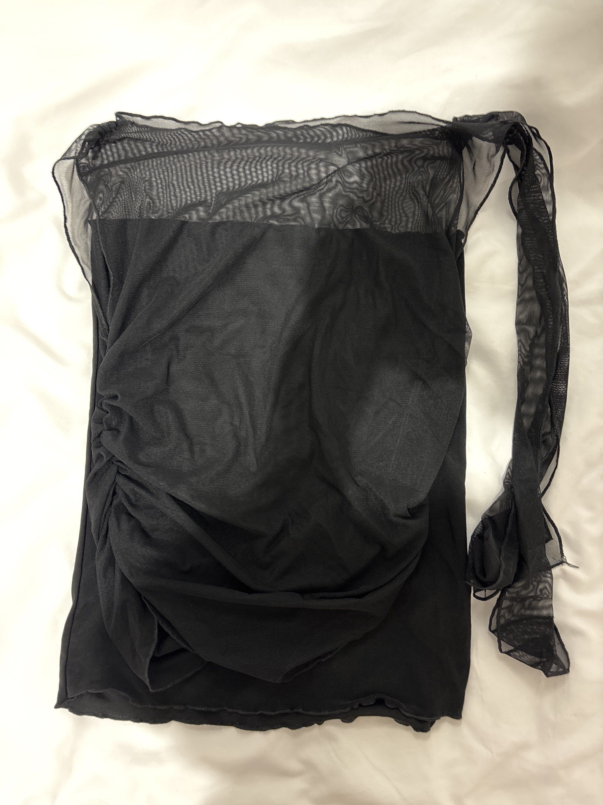 Black Mesh Tube Tie Top (Category: Dresses) located in Mandaluyong City. Submitted by castpreloveds (Listing ID 1420255659, Image 1). Description: - USED ONLY TWICE - Black mesh tie top & black tube - Ruched front detail - Flowing, sheer overlay - Sleeveless design - Includes separate tie fabric - Delicate, see-through fabric.