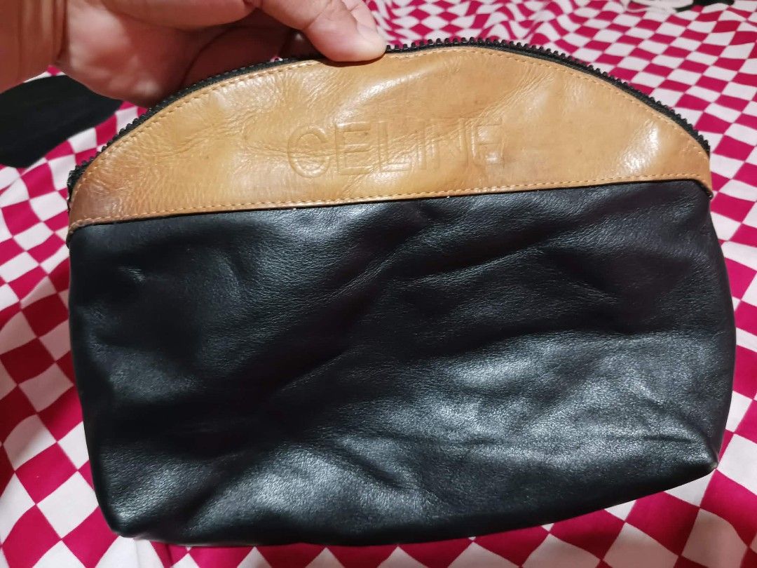 Celine Leather Clutch (Category: Luxury Bags & Wallets) located in Roxas City. Submitted by tabot (Listing ID 1420333874, Image 3). Description: - Ukay2x Celine clutch - Color: Black and tan leather - Features a top zipper closure - Black leather lining - Celine logo embossed.