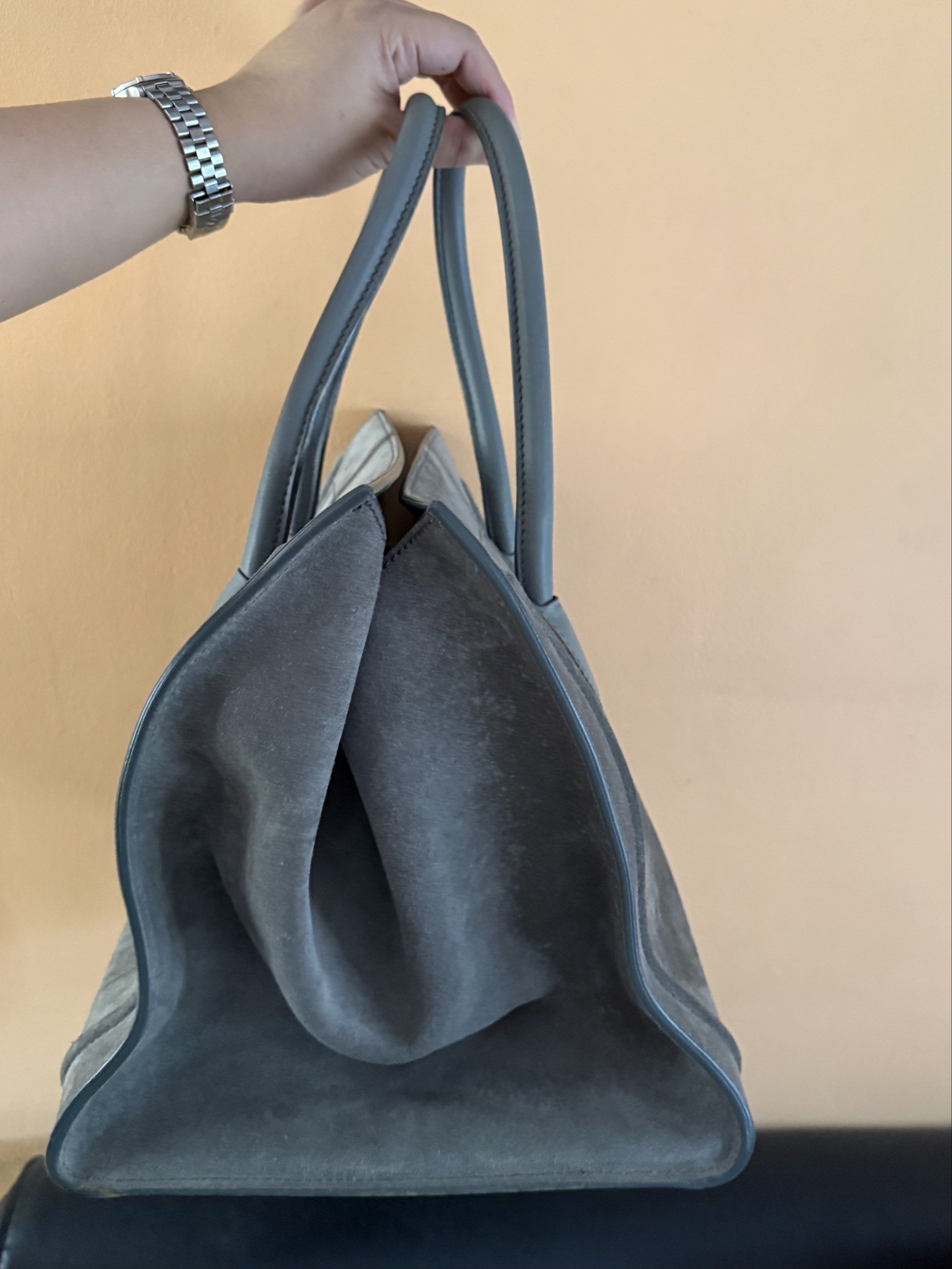 Celine Phantom Suede Handbag (Category: Luxury Bags & Wallets) located in Malolos. Submitted by prelovedbydrjen (Listing ID 1420212580, Image 3). Description: - Authentic Celine Phantom handbag - Grey suede exterior - Matching leather handles and trim - Front zipper pocket with braided leather pull - Interior zippered pocket - Celine Paris logo - Light grey handles.