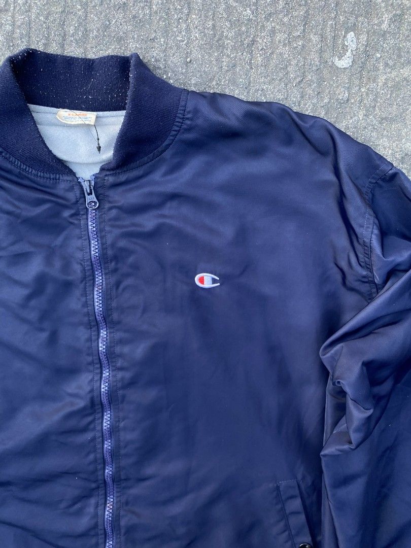 Champion Navy Bomber Jacket (Category: Coats, Jackets and Outerwear) located in Manila. Submitted by thrift2something (Listing ID 1420345203, Image 2). Description: - Navy blue Champion bomber jacket - Full zip closure - Two front pockets - Ribbed cuffs and hem - Champion logo on chest and left sleeve - Lightweight material - Classic bomber jacket style.