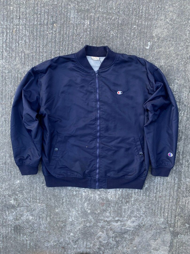 Champion Navy Bomber Jacket (Category: Coats, Jackets and Outerwear) located in Manila. Submitted by thrift2something (Listing ID 1420345203, Image 1). Description: - Navy blue Champion bomber jacket - Full zip closure - Two front pockets - Ribbed cuffs and hem - Champion logo on chest and left sleeve - Lightweight material - Classic bomber jacket style.