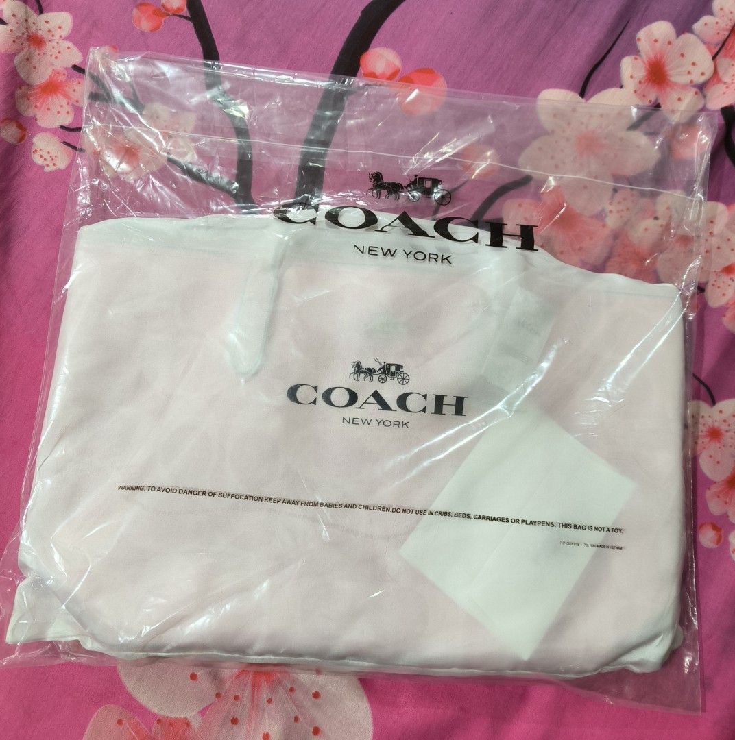 Coach Pink Tote Bag (Category: Luxury Bags & Wallets) located in Cavite. Submitted by jenniferst88424 (Listing ID 1420254571, Image 2). Description: - Coach tote bag - Pink color with Coach logo pattern - Includes dust bag, tags, and care card - Magnetic closure - Multiple interior pockets - Light pink interior - brand new.