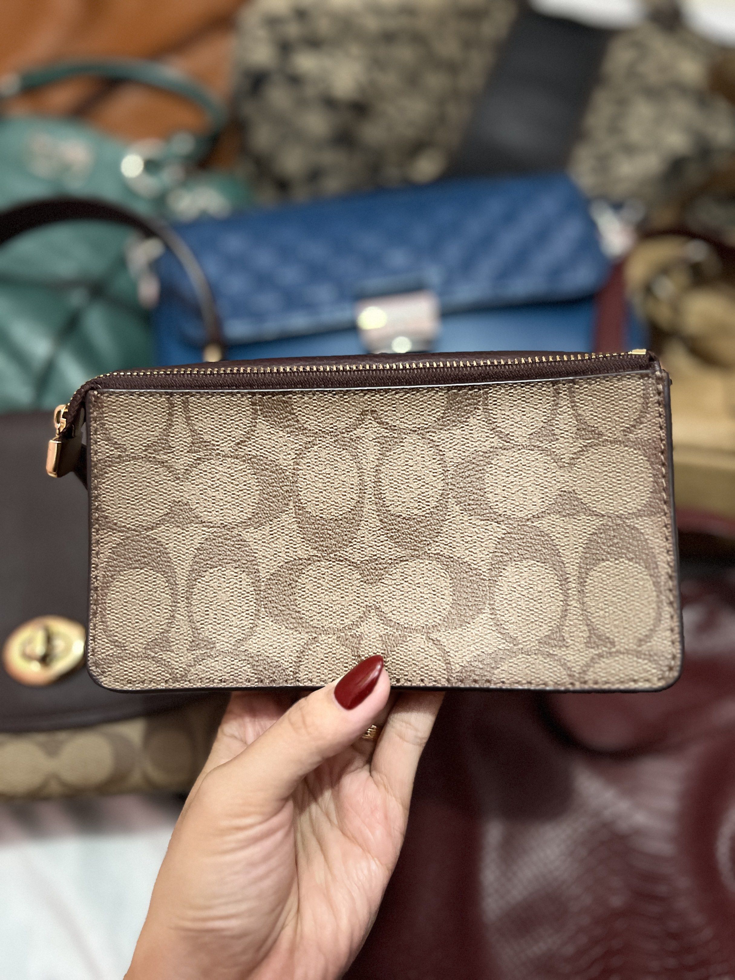 Coach Signature Wallet (Category: Luxury Bags & Wallets) located in Navotas City. Submitted by declutteringstuff_ph (Listing ID 1420178354, Image 3). Description: - Coach wallet with signature print - Includes a wrist strap - Features a brown leather top - Secure zip closure - Interior with card slots and snap closure - Shows wear and tear inside.
