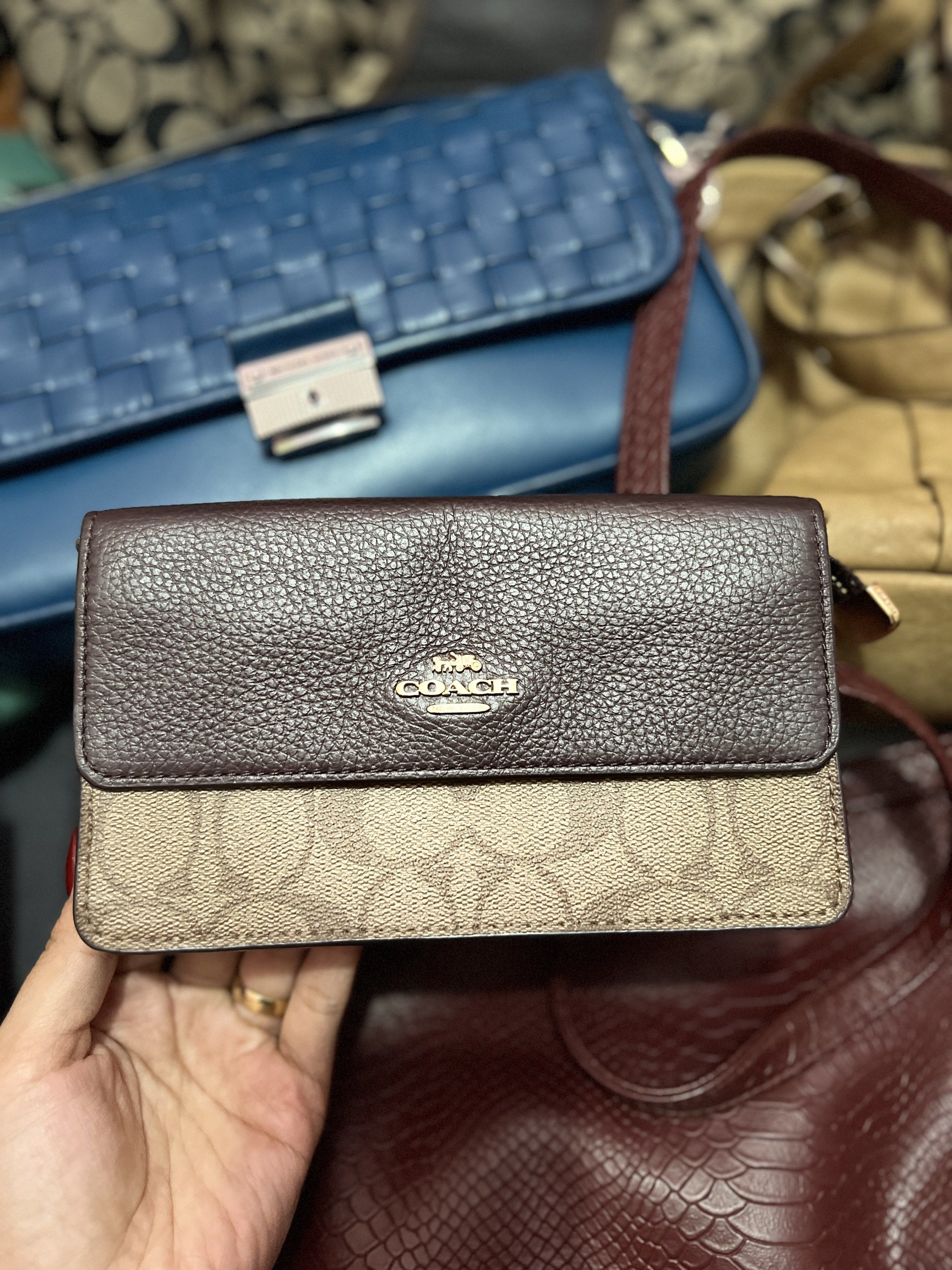 Coach Signature Wallet (Category: Luxury Bags & Wallets) located in Navotas City. Submitted by declutteringstuff_ph (Listing ID 1420178354, Image 2). Description: - Coach wallet with signature print - Includes a wrist strap - Features a brown leather top - Secure zip closure - Interior with card slots and snap closure - Shows wear and tear inside.