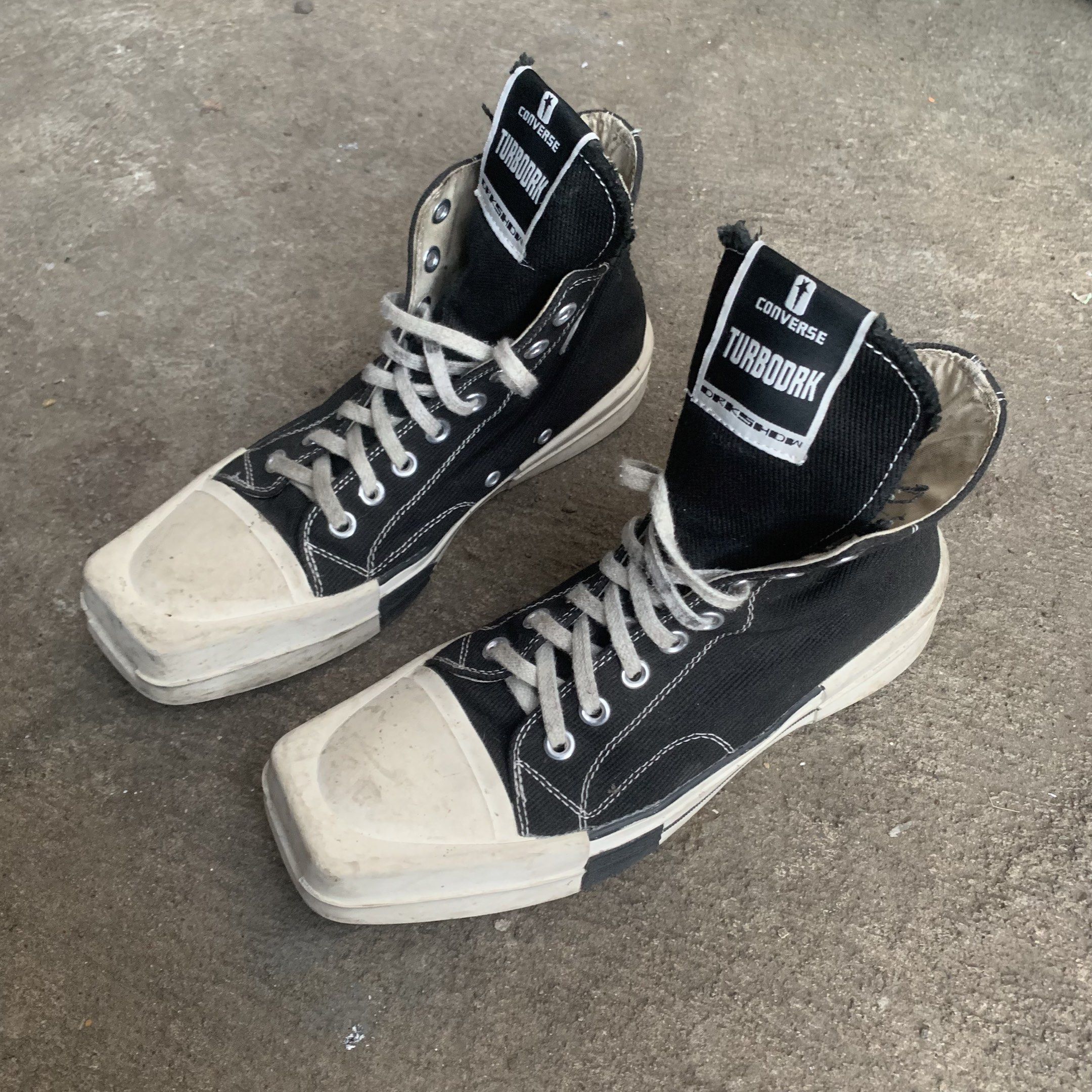 Rick Owens Converse TURBODRK High Top (Category: Sneakers) located in Davao. Submitted by isellstuff357 (Listing ID 1420252869, Image 2). Description: - Converse Chuck 70 TURBODRK High Top - Black colorway - US Size 11 / EUR 43 - Unique square toe design - High-top silhouette - Made in Vietnam - Features white laces and sole - Converse logo visible.