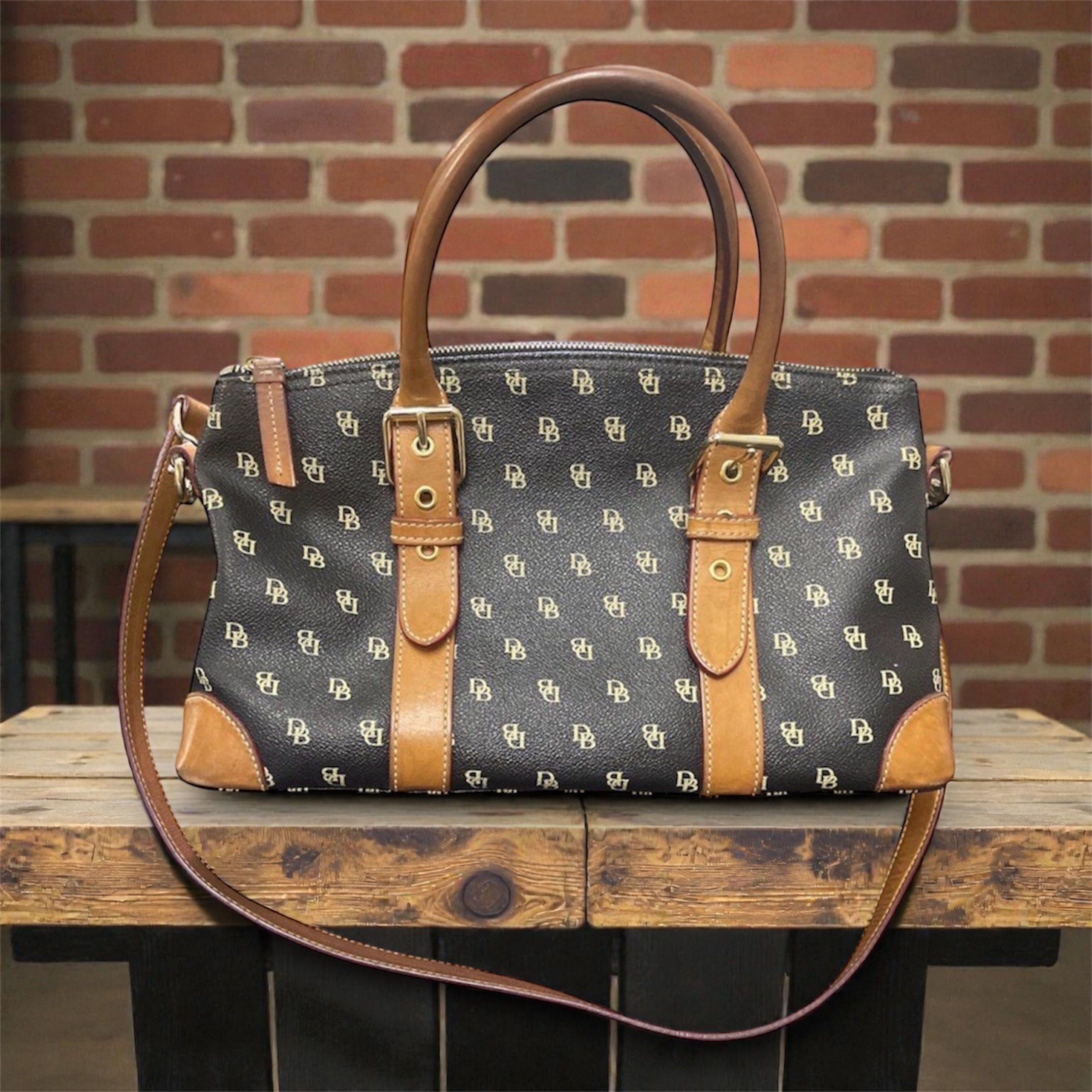 Dooney & Bourke Black and Brown Bag (Category: Luxury Bags & Wallets) located in Santa Rosa. Submitted by yen.ph (Listing ID 1361851451, Image 1). Description: Color: Black with tan trimming Size (Approx): 13in (W) x 8in (H) x 5in (D) Bought from the US. 100% original Dooney & Bourke bag.