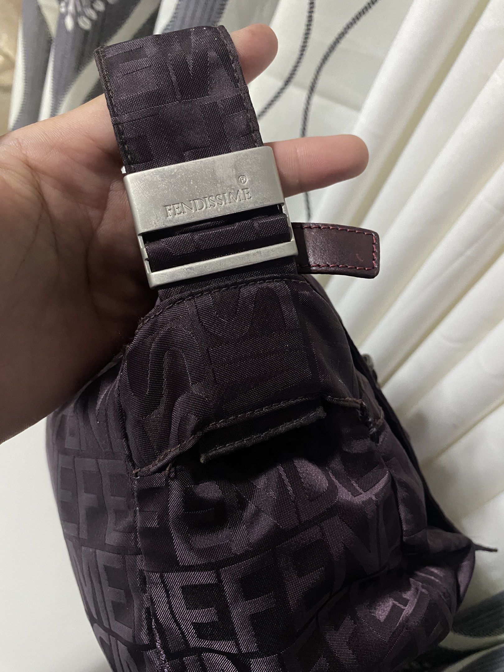 FENDISSIME Crossbody Bag (Category: Luxury Bags & Wallets) located in Tagum. Submitted by amarasluxbag (Listing ID 1420298535, Image 2). Description: - FENDISSIME crossbody bag - Repeating logo pattern - Zippered main compartment - Secondary zippered pocket inside - Adjustable shoulder strap - Textured interior lining - Metal buckle with brand name - Made in Italy With sign of use Mayparang tinahi na part Maganda color neto Magaan lang .
