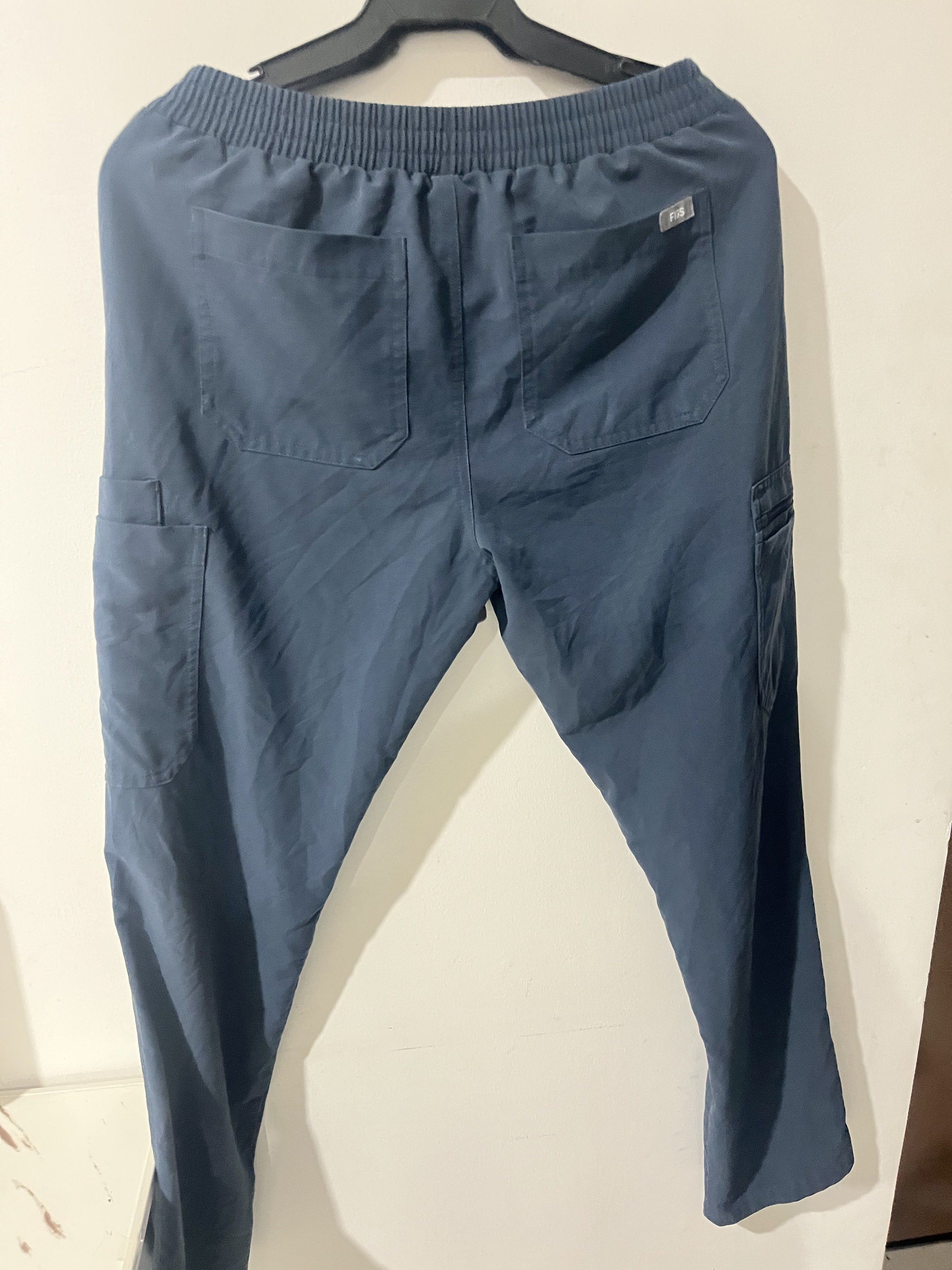 FIGS Technical Collection Scrub Pants - Navy Blue (Category: Other Bottoms) located in Manila. Submitted by checkmylisting (Listing ID 1420308413, Image 3). Description: - Navy blue FIGS scrub pants - Size: Small - Features: Drawstring waist, multiple pockets (including cargo pockets), and a small logo - Material: Technical fabric - Perfect for medical professionals or anyone needing comfortable and functional pants.