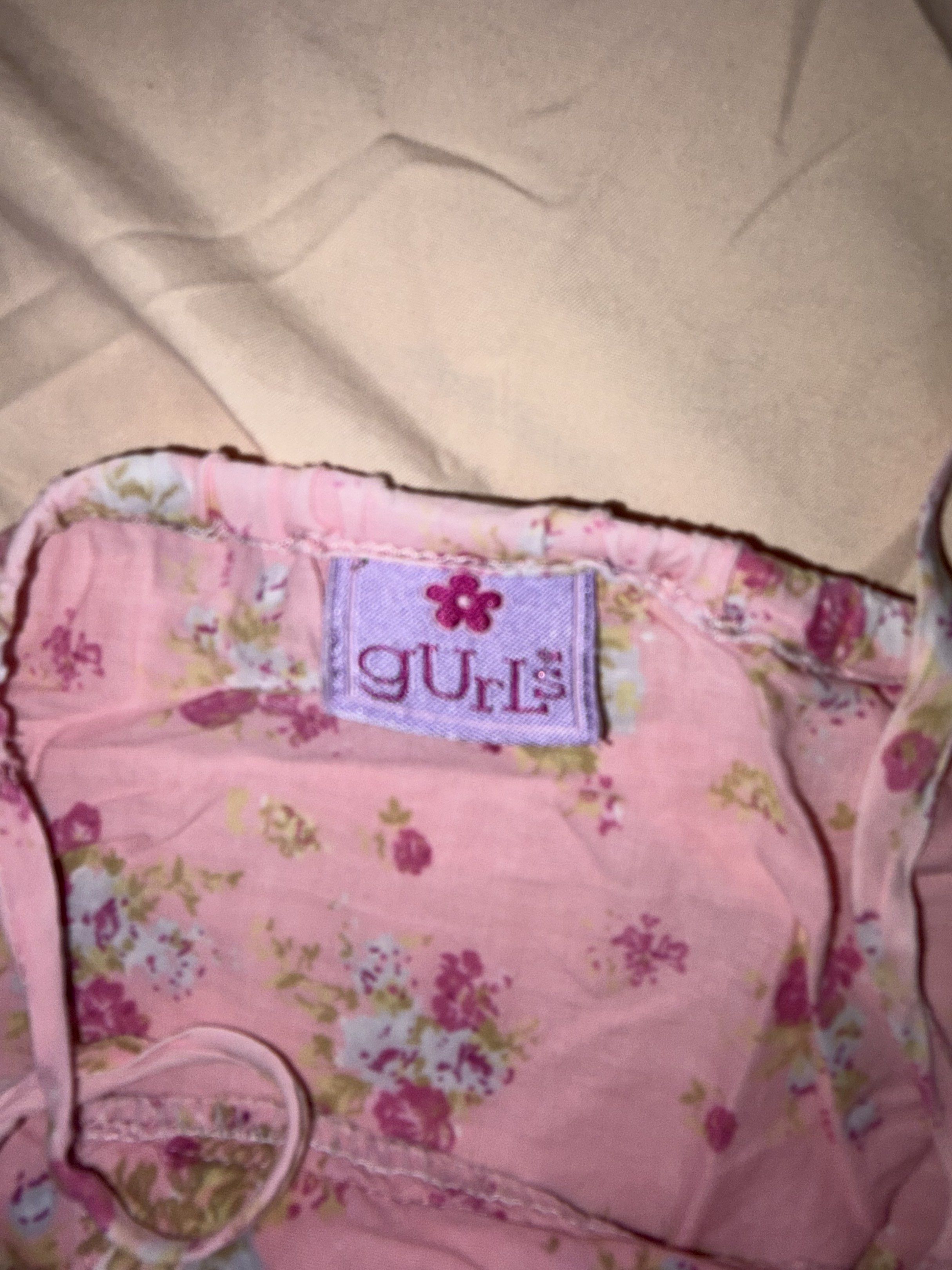 Gurls Floral Dress (Category: Dresses) located in San Pedro. Submitted by redvanity.ph (Listing ID 1420323334, Image 3). Description: - Brand: Gurls - Features a beautiful floral print in pink and purple. - Design: Spaghetti straps, tiered style with a ruffled hem. - Fabric: Lightweight, ideal for warm weather. - Neckline: V-neck - Fit: Comfortable and flowy.