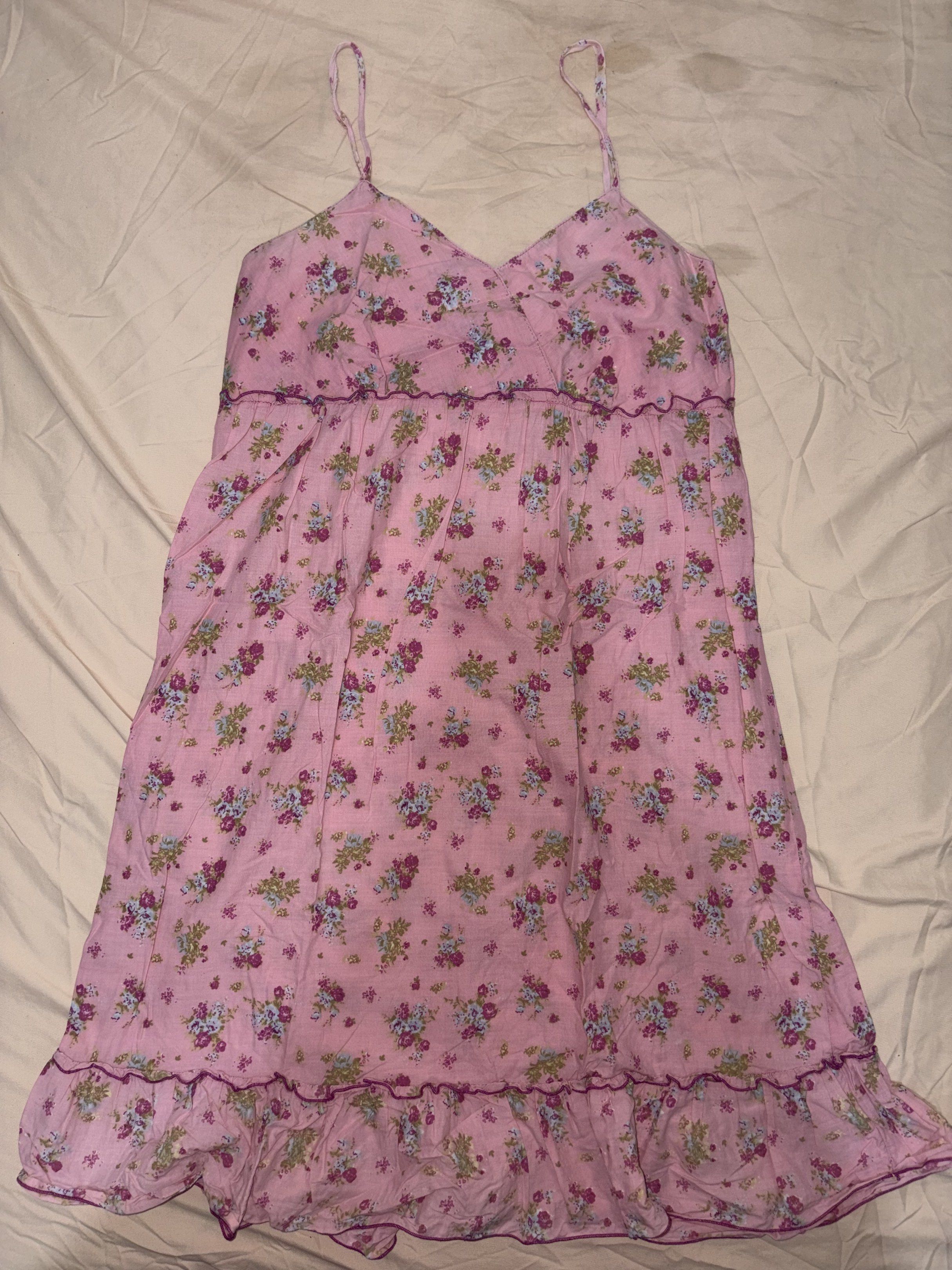 Gurls Floral Dress (Category: Dresses) located in San Pedro. Submitted by redvanity.ph (Listing ID 1420323334, Image 2). Description: - Brand: Gurls - Features a beautiful floral print in pink and purple. - Design: Spaghetti straps, tiered style with a ruffled hem. - Fabric: Lightweight, ideal for warm weather. - Neckline: V-neck - Fit: Comfortable and flowy.