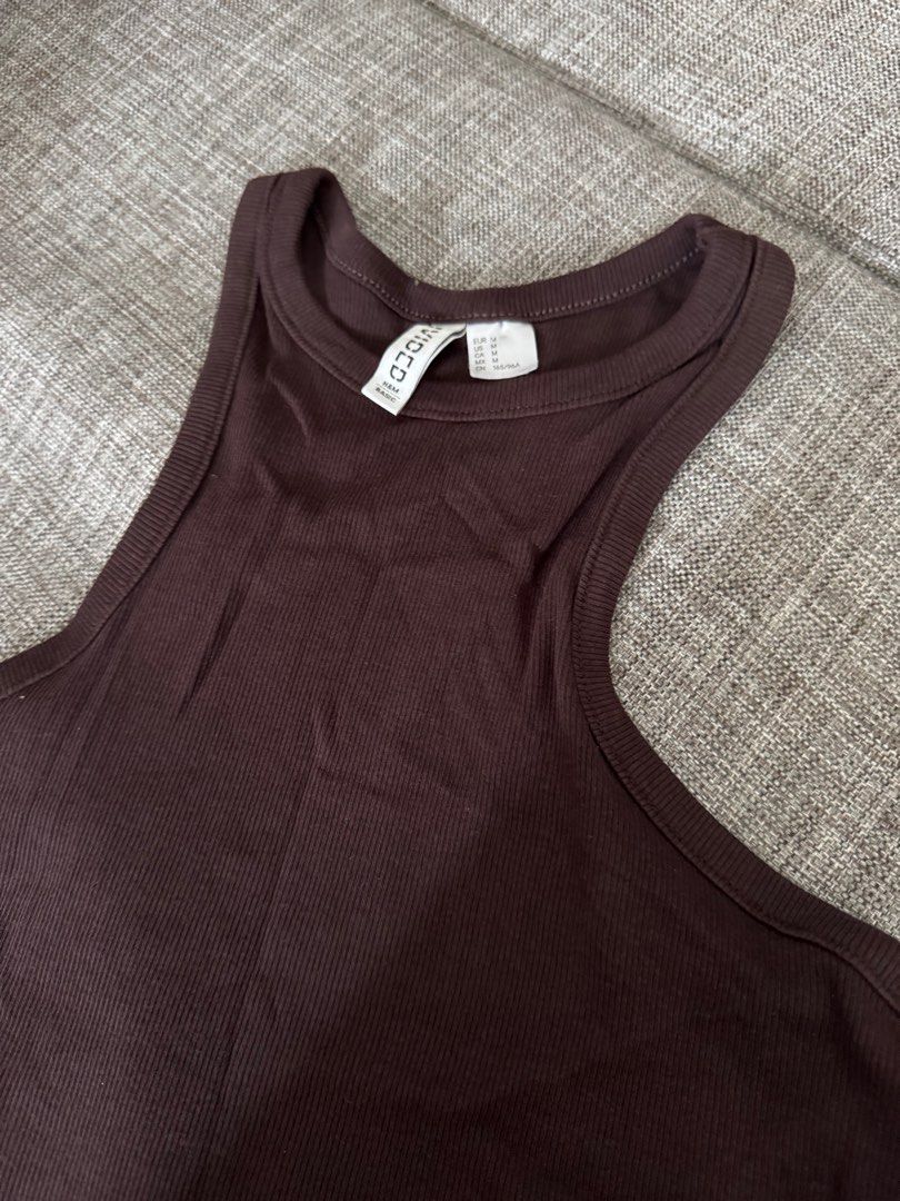 H&M Divided Basic Ribbed Tank Top - Brown (Category: Sleeveless) located in Quezon City. Submitted by cessdecluttering (Listing ID 1420231276, Image 3). Description: - H&M Divided Basic Tank Top - Size: M - Color: Brown - Features: Ribbed texture, halter neckline - Versatile: Perfect for layering or wearing alone - Fabric: Soft and breathable - Style: Comfortable and stylish.
