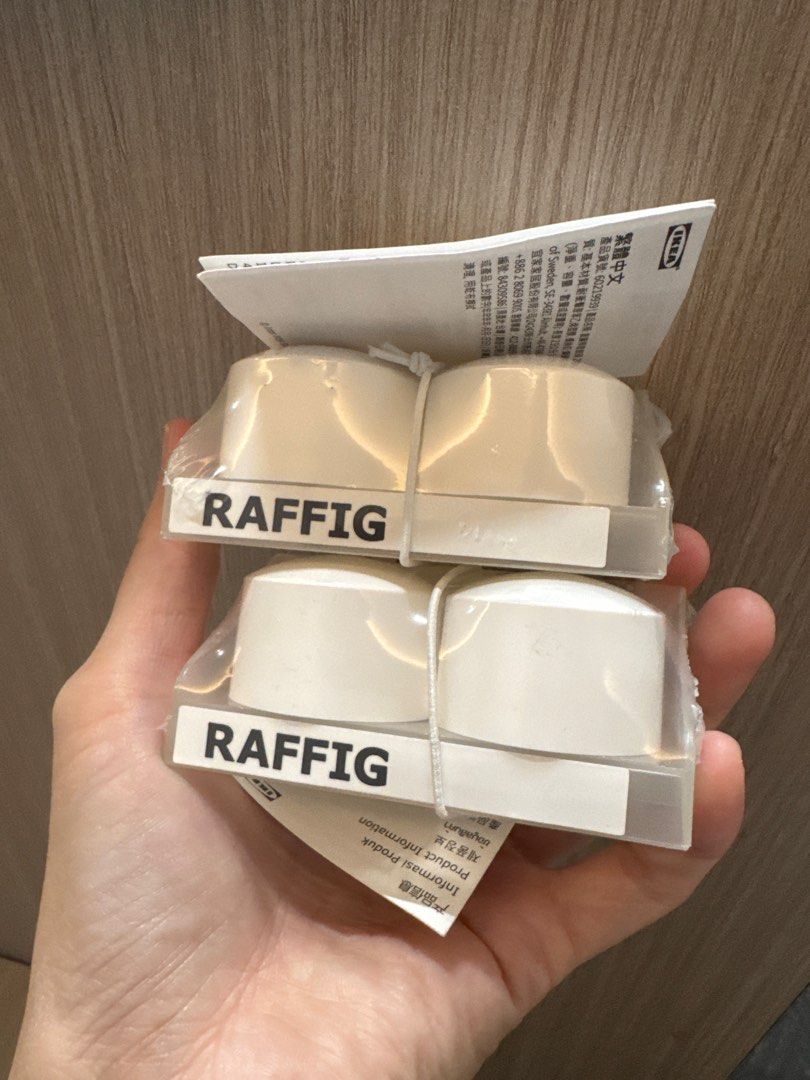 IKEA RAFFIG Drawer Knobs (Category: Shelves, Cabinets & Racks) located in Singapore. Submitted by kaylasg77 (Listing ID 1420208538, Image 1). Description: - New IKEA RAFFIG drawer knobs. - Includes two sets: white and beige. - Each set contains four knobs. - Perfect for drawers and cabinets. - Unused and in original packaging..