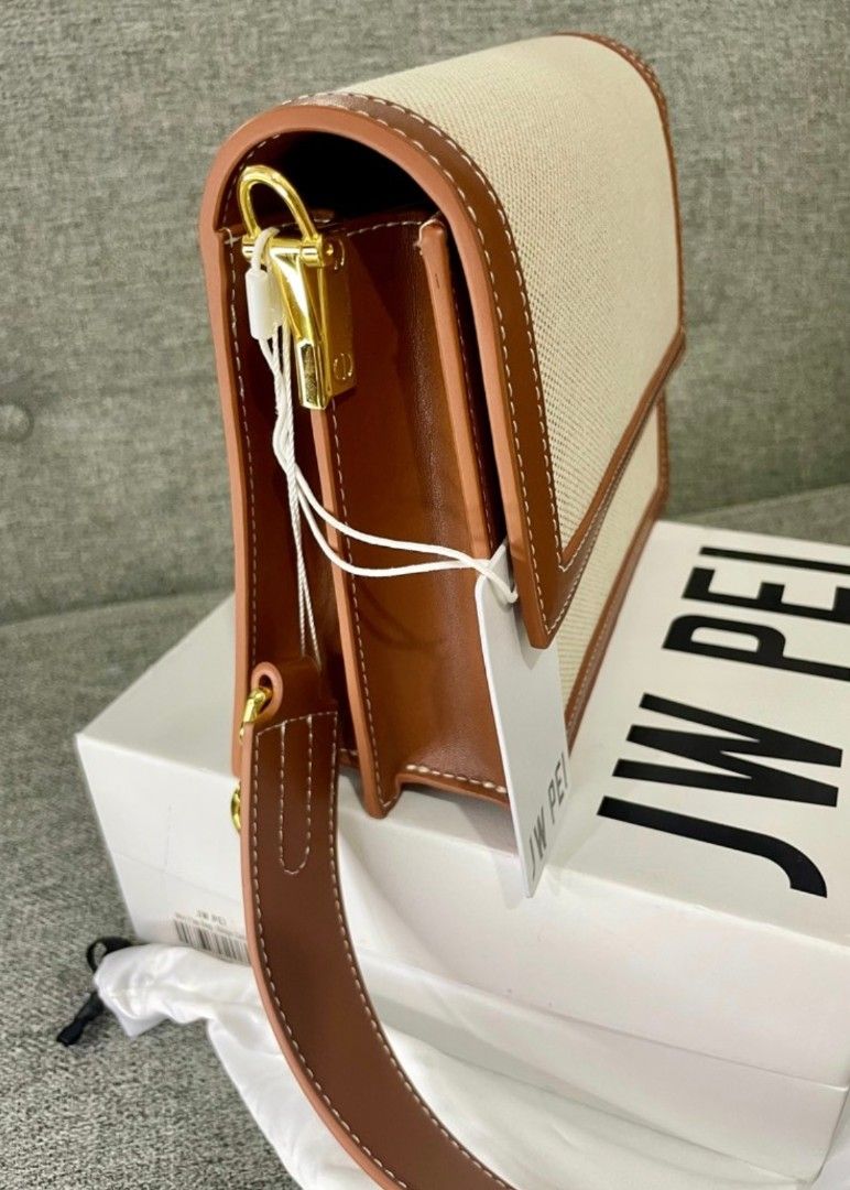 JW PEI Bag (Category: Luxury Bags & Wallets) located in Pasig City. Submitted by reesekirsten_ (Listing ID 1420207987, Image 2). Description: JW PEI Gabbi bag in a beige and brown color combination. Features a canvas body with brown leather trim and strap. Includes a gold-tone clasp and hardware. Comes with the original box and dust bag. The bag has a serial number G3W6L-104-9-03-0417..