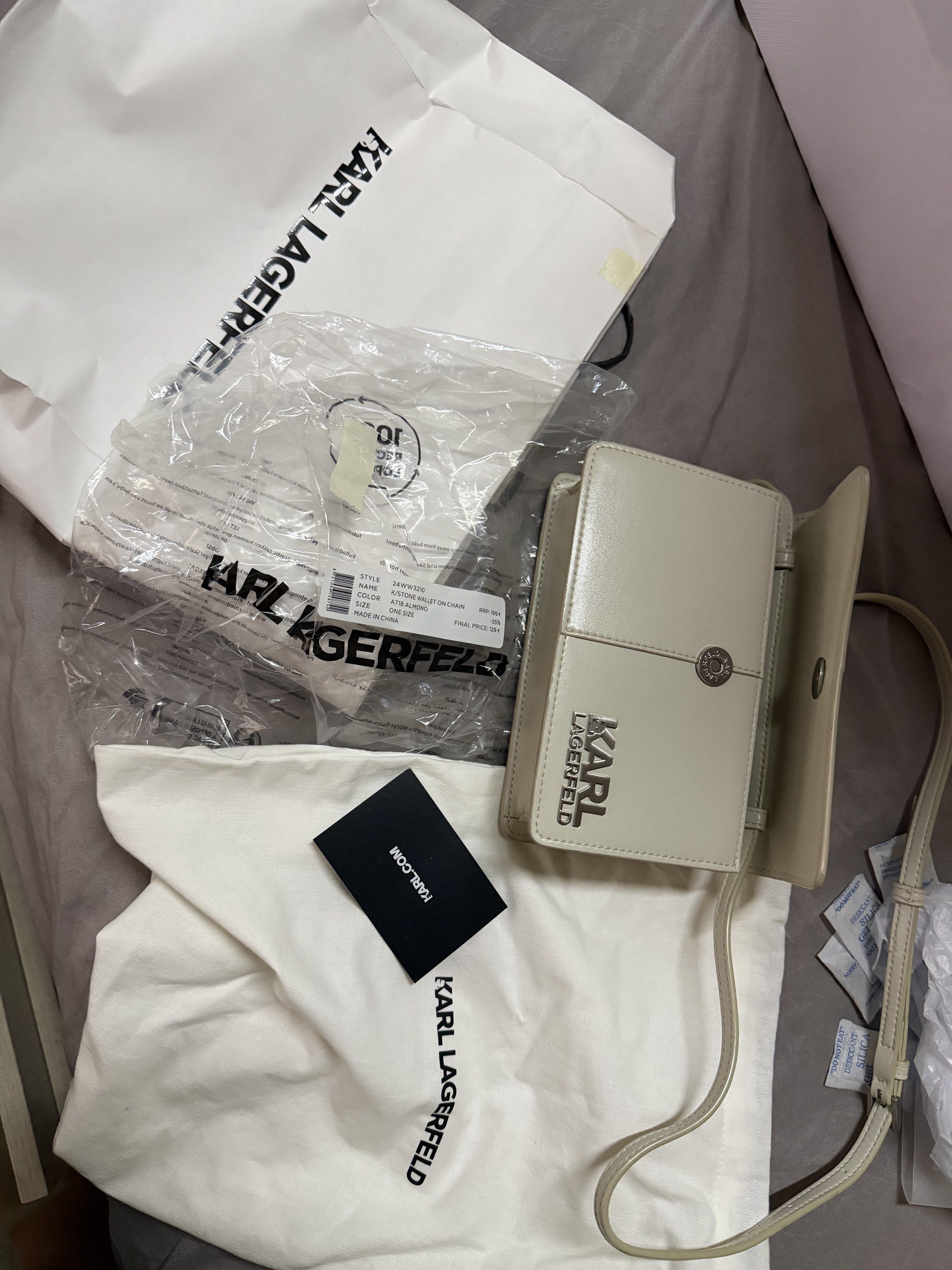 Karl Lagerfeld Shoulder Bag (Category: Cross-body Bags) located in Caloocan City. Submitted by bbkk08 (Listing ID 1420218097, Image 1). Description: Authentic Karl Lagerfeld crossbody bag in a neutral color. Features a flap closure and long strap. Includes original dust bag, shopping bag, and authenticity card. Perfect for everyday essentials..