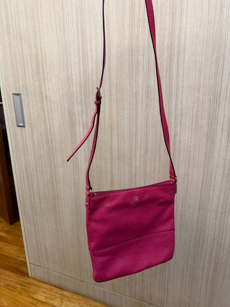 Kate Spade Pink Leather Crossbody Bag (Category: Cross-body Bags) located in Manila. Submitted by mts7890 (Listing ID 1420164550, Image 2). Description: - Kate Spade crossbody bag - Vibrant pink color - Textured leather exterior - Adjustable long strap - Zip closure - Small logo detail - Compact size - Simple and elegant design.