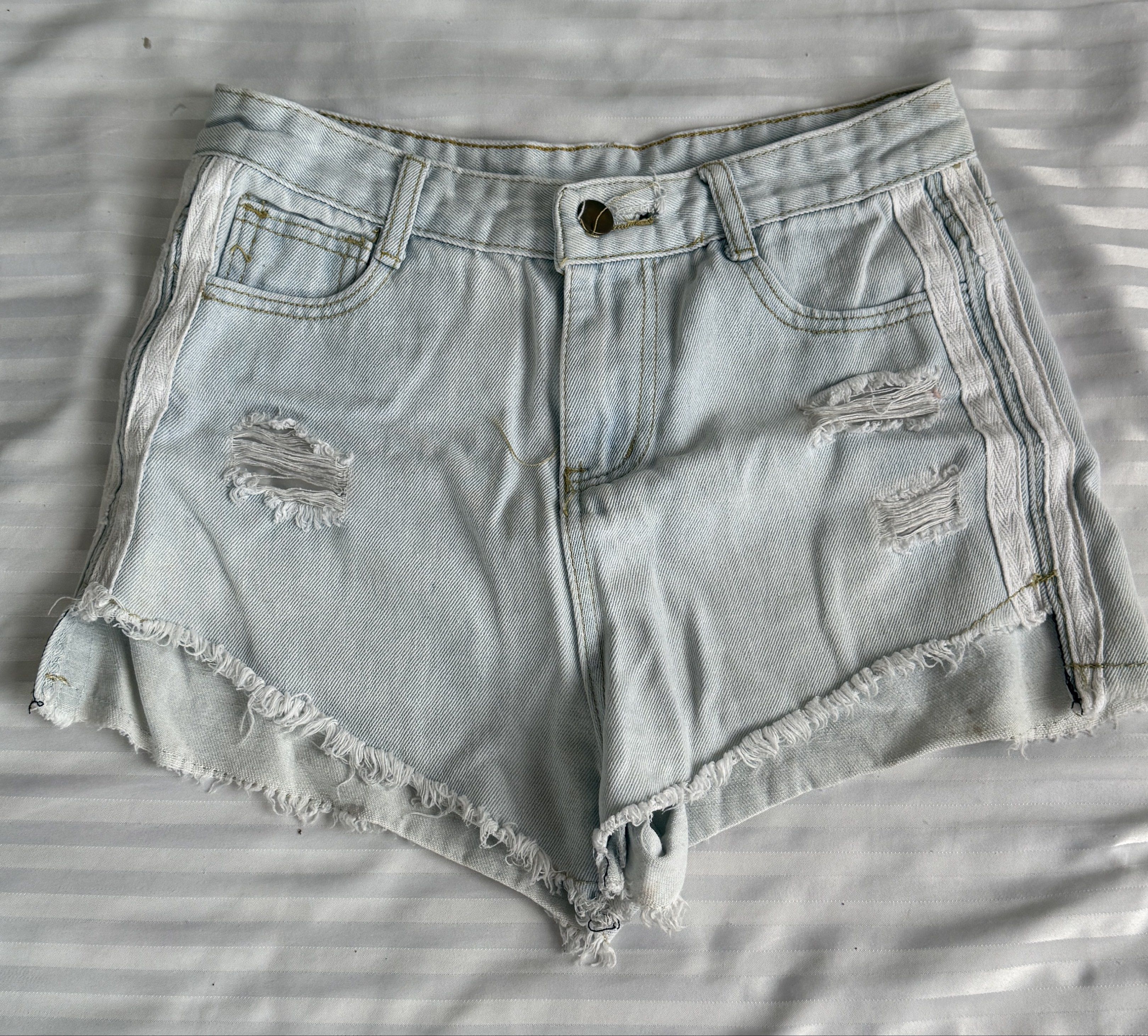 Light Wash Denim Shorts with Side Stripes (Category: Shorts) located in Lucban. Submitted by milesj. (Listing ID 1420175859, Image 1). Description: - Light wash denim shorts - Distressed details and raw hem - White side stripes - Classic five-pocket design - Button and zipper closure - Two back pockets and two front pockets - Perfect for casual wear.
