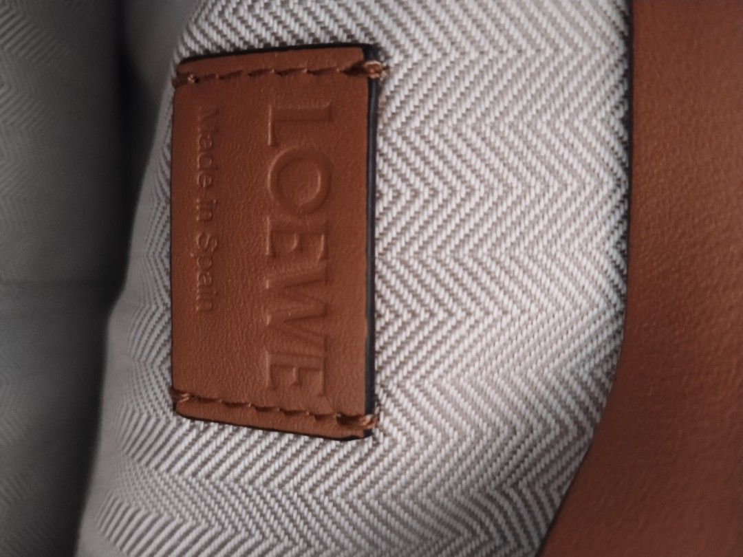 Loewe Cat Clutch (Category: Luxury Bags & Wallets) located in Bayombong. Submitted by rnstrifty (Listing ID 1420176012, Image 2). Description: - Loewe cat clutch - Tan exterior - Zip closure - Wrist strap - Patterned interior lining - Interior pocket - Made in Spain.