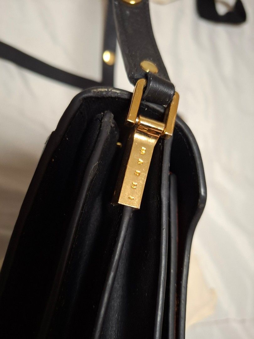 Marni Trunk Shoulder Bag (Category: Luxury Bags & Wallets) located in Ilagan. Submitted by dbankerscloset (Listing ID 1420320729, Image 3). Description: - Marni Trunk shoulder bag - Color block design - Black exterior with blue and orange accents - Detachable shoulder strap - Multiple interior compartments - Gold-tone zippers and clasp - Brand name visible on hardware - Includes dust bag.