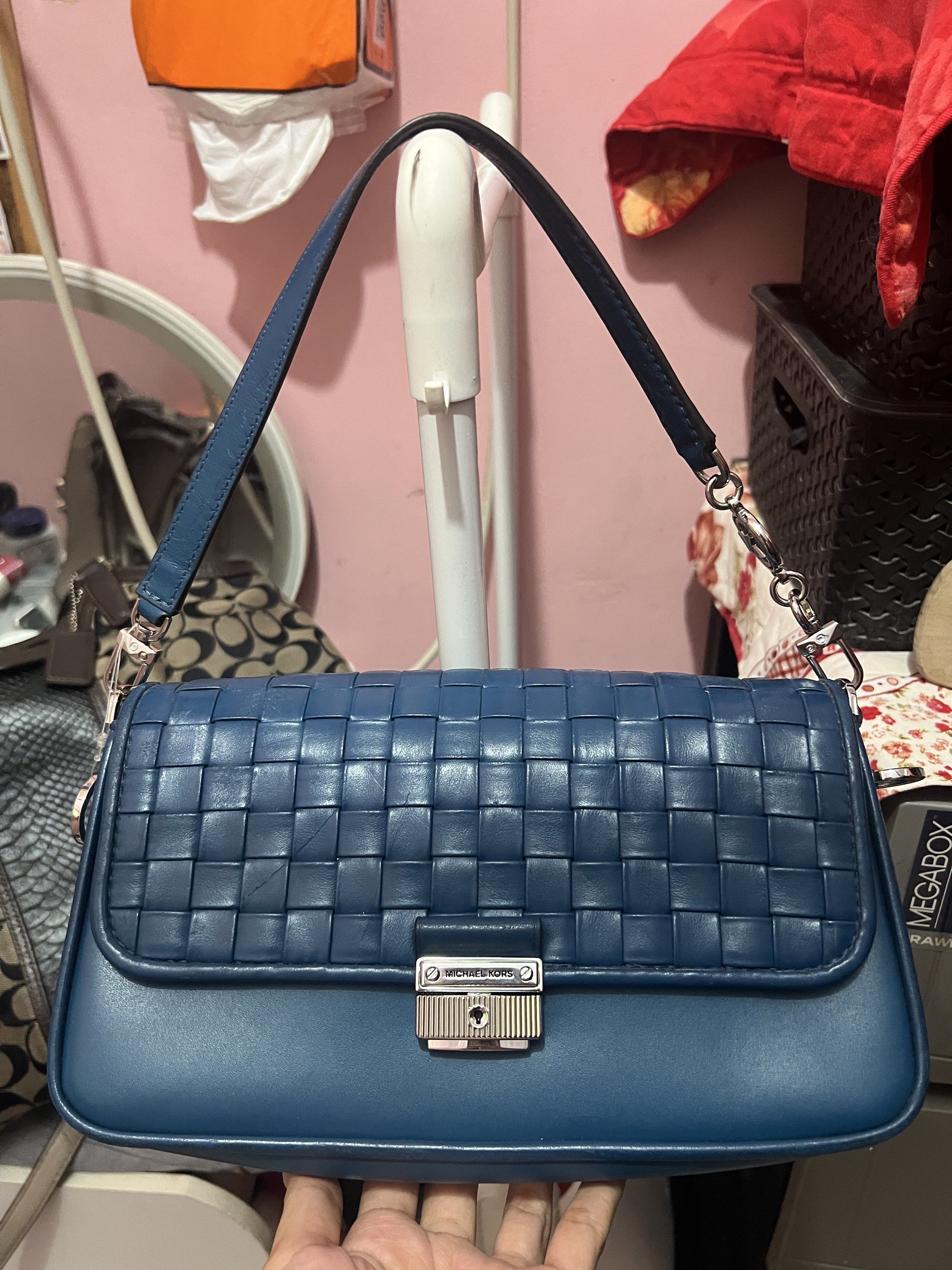 Michael Kors Woven Leather Shoulder Bag (Category: Luxury Bags & Wallets) located in Navotas City. Submitted by declutteringstuff_ph (Listing ID 1420177930, Image 1). Description: - Michael Kors shoulder bag - Woven design - Flap closure with logo - Detachable shoulder strap - Interior zippered pocket - Deep blue color - Silver-toned hardware Original.