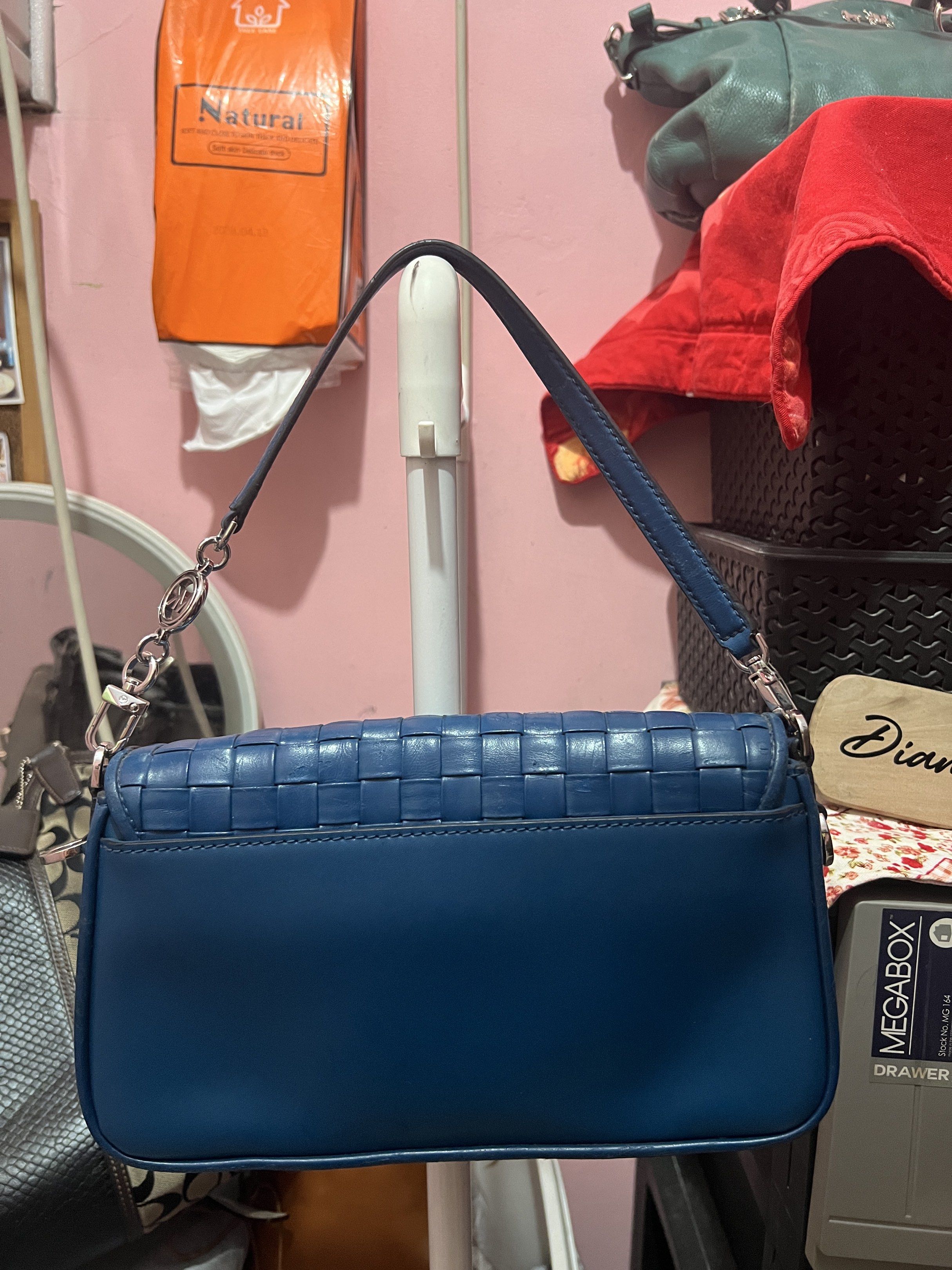 Michael Kors Woven Leather Shoulder Bag (Category: Luxury Bags & Wallets) located in Navotas City. Submitted by declutteringstuff_ph (Listing ID 1420177930, Image 2). Description: - Michael Kors shoulder bag - Woven design - Flap closure with logo - Detachable shoulder strap - Interior zippered pocket - Deep blue color - Silver-toned hardware Original.