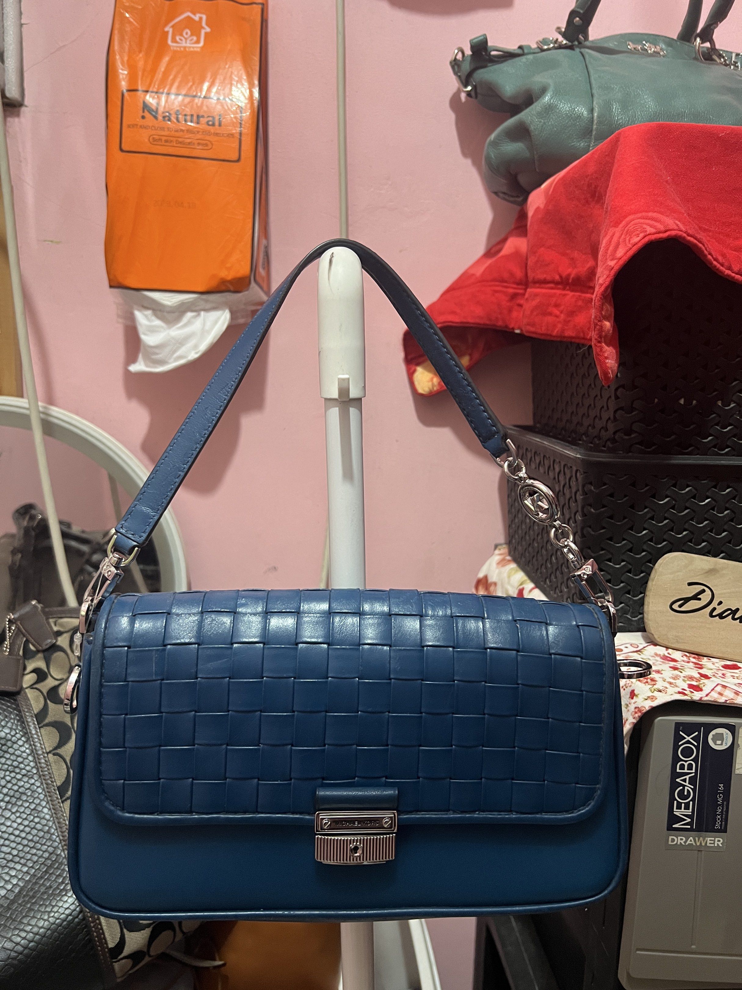 Michael Kors Woven Leather Shoulder Bag (Category: Luxury Bags & Wallets) located in Navotas City. Submitted by declutteringstuff_ph (Listing ID 1420177930, Image 3). Description: - Michael Kors shoulder bag - Woven design - Flap closure with logo - Detachable shoulder strap - Interior zippered pocket - Deep blue color - Silver-toned hardware Original.