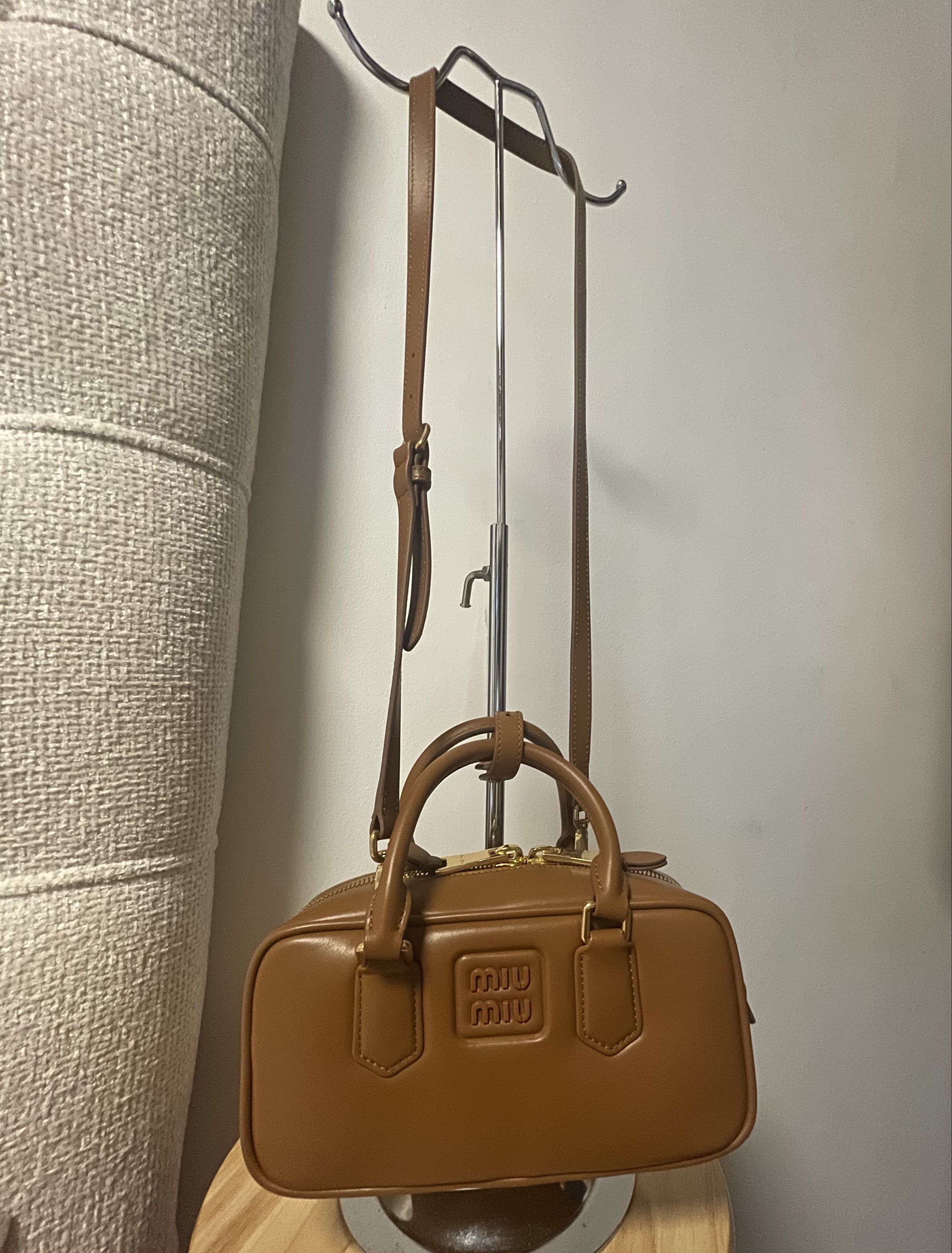 Miu Miu Brown Leather Handbag (Category: Luxury Bags & Wallets) located in Cavite. Submitted by marshwind (Listing ID 1407251336, Image 2). Description: Miu Miu Caramel Leather Small Arcadie Handbag w/ Sling - Miu Miu brown leather handbag - Top handle and detachable shoulder strap - Rectangular shape - Zip closure - Embossed Miu Miu logo - Gold-tone hardware - Classic and versatile design.