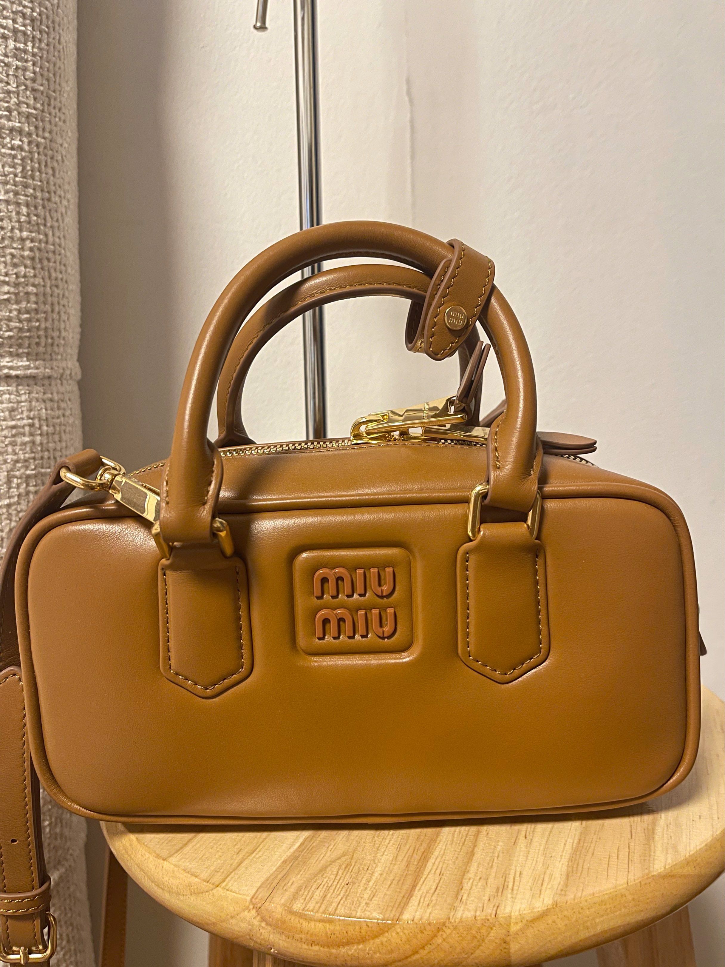 Miu Miu Brown Leather Handbag (Category: Luxury Bags & Wallets) located in Cavite. Submitted by marshwind (Listing ID 1407251336, Image 1). Description: Miu Miu Caramel Leather Small Arcadie Handbag w/ Sling - Miu Miu brown leather handbag - Top handle and detachable shoulder strap - Rectangular shape - Zip closure - Embossed Miu Miu logo - Gold-tone hardware - Classic and versatile design.