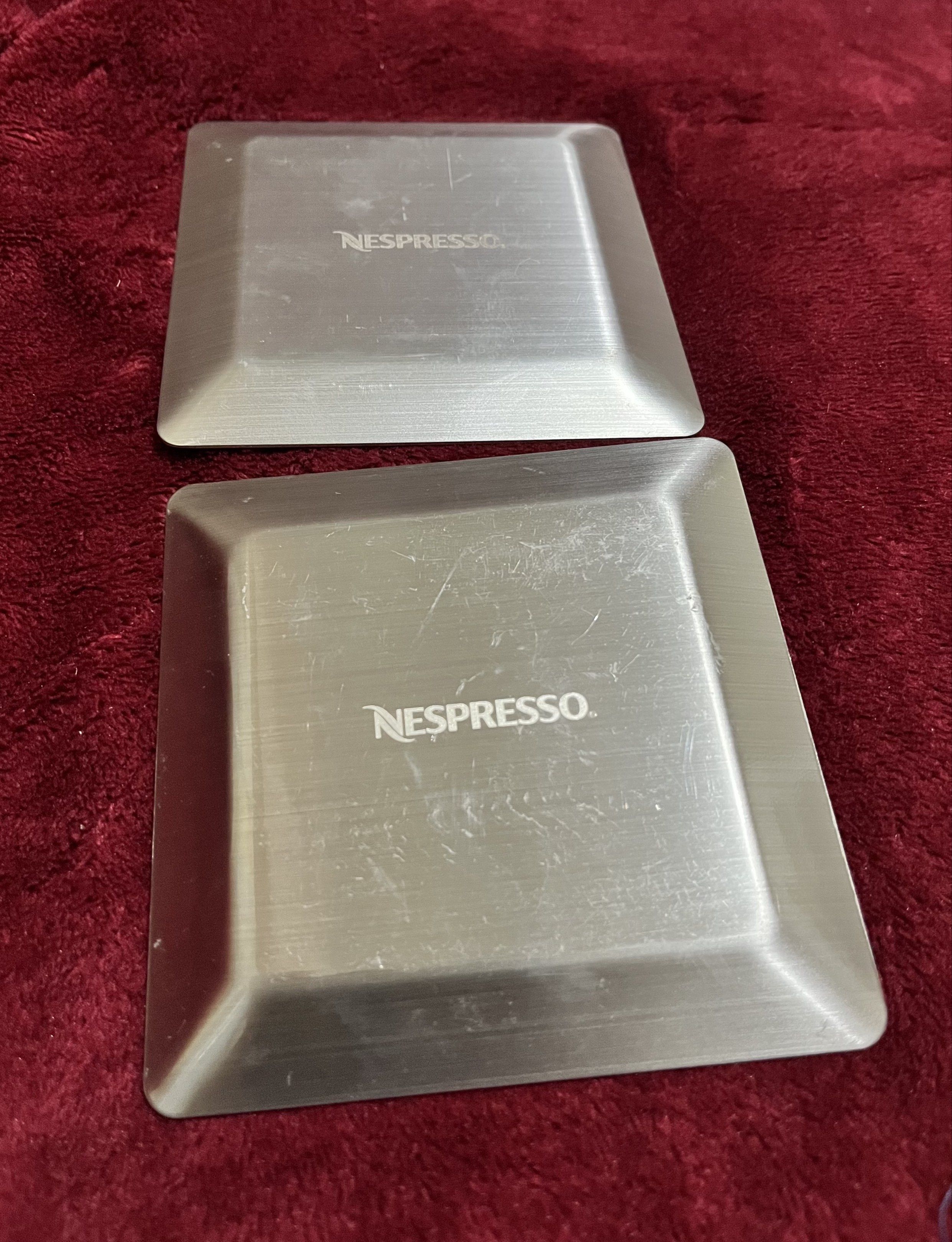 Nespresso Metal Coasters/ Small Serving Dish 2 pcs (Category: Coffee & Tea Tableware) located in La Trinidad. Submitted by whatnotcollections (Listing ID 1420285553, Image 2). Description: - Set of two Nespresso stainless steel coasters. - Features a brushed steel finish. - Showcases the Nespresso logo. - Adds a touch of elegance to your coffee setup. - Protects surfaces from spills and heat. - approximately 4” x 4” Slightly negotiable for sure b