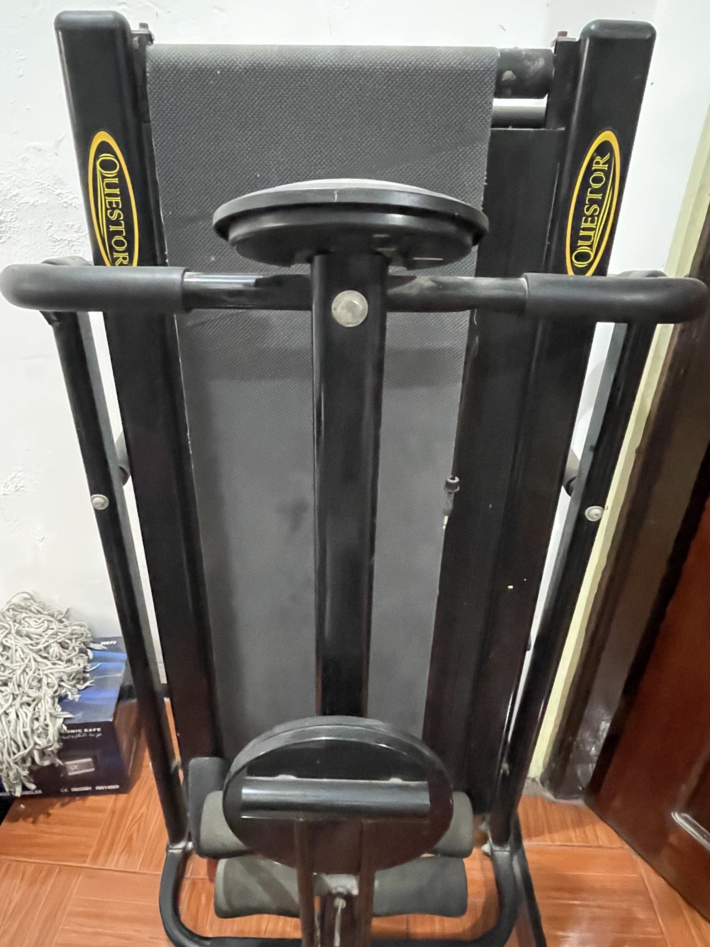 Questor ST-8268-3 Treadmill (Category: Cardio & Fitness Machines) located in Rizal. Submitted by awearhouseboutique (Listing ID 1420250571, Image 3). Description: Questor ST-8268-3 treadmill. Features a black frame with a running belt. Includes armrests and a lower support for sit-ups. The treadmill can be folded for storage. The Questor logo is visible on the frame. The model number ST-8268-3 is also visible..