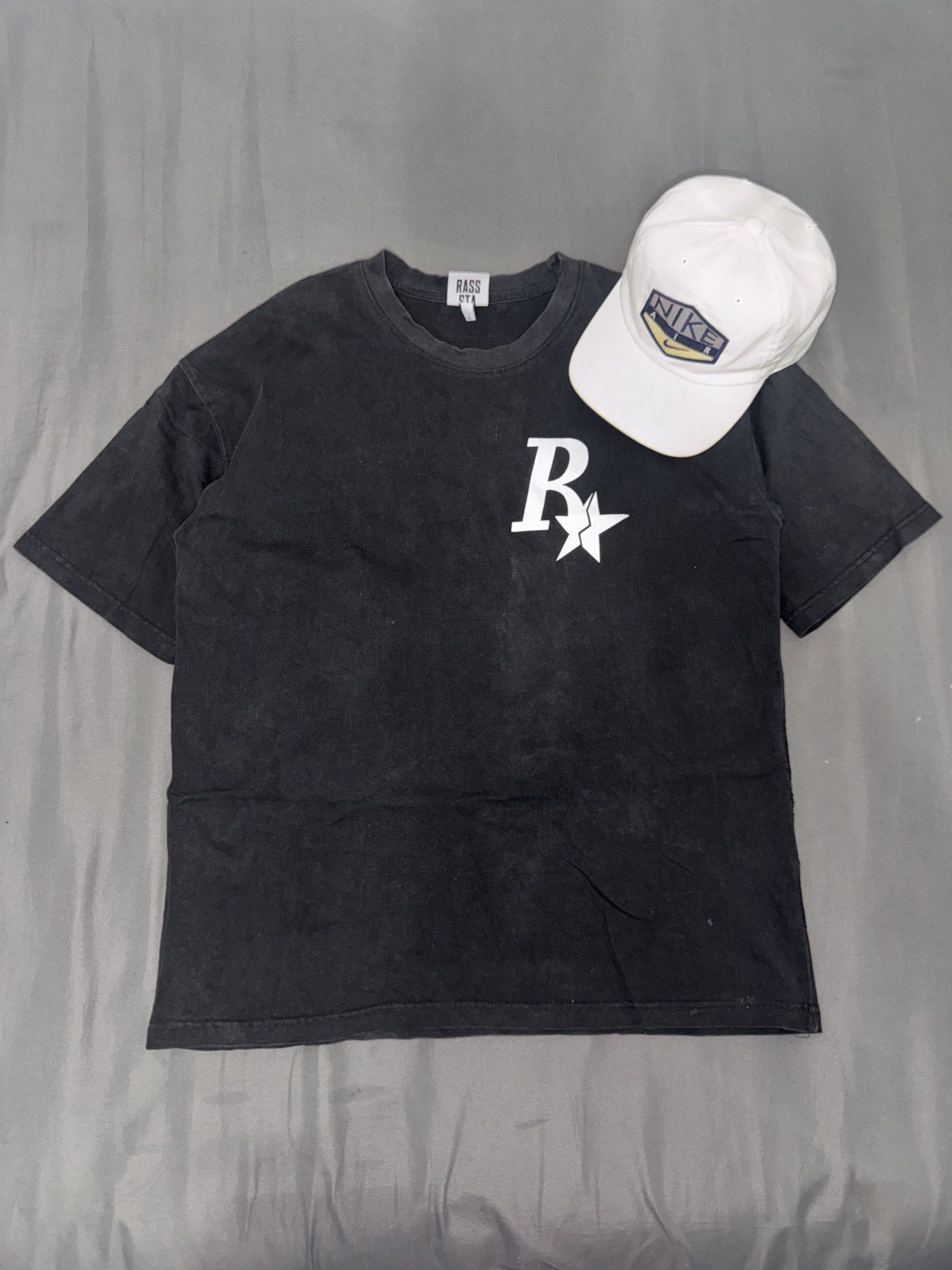 Rass Sta XL Black T-shirt (Category: Tshirts & Polo Shirts ) located in Manila. Submitted by jpabss (Listing ID 1420344164, Image 1). Description: 💥Black Rass Sta T-shirt 💥Design: Large white "R" and star on front and back 💥Condition: 9/10 💥Width: 22 💥Length: 28 💥Issue: Need Restitch on Left Side (I’ll Send Pic if interested).