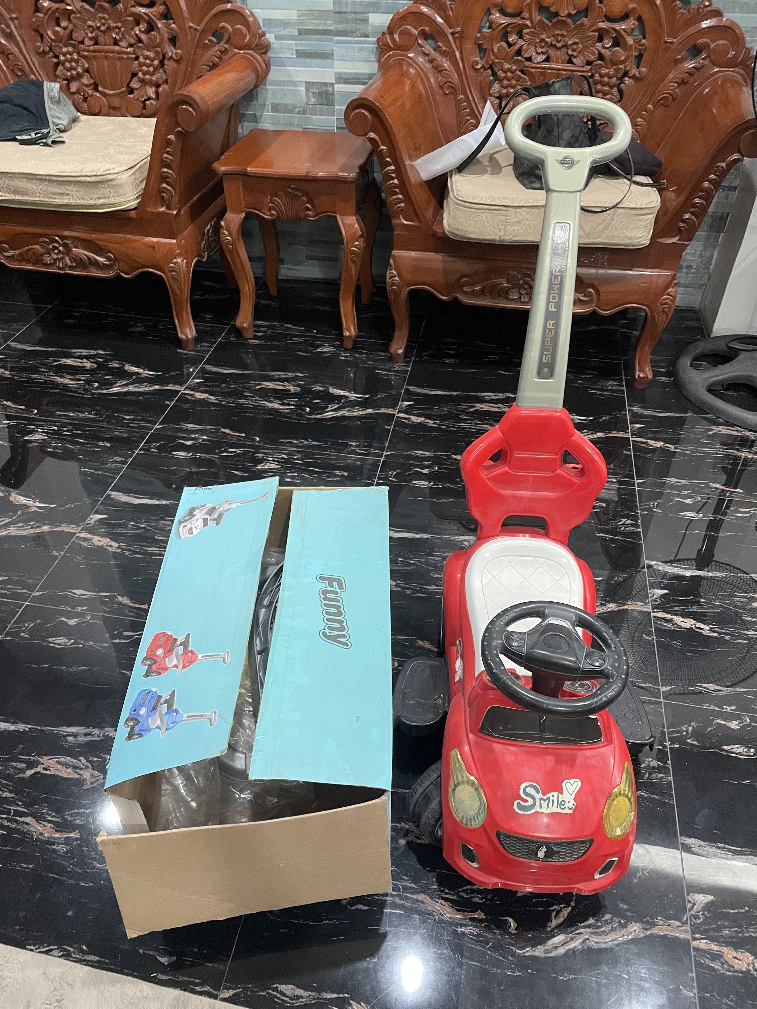 Ride-on Car with Push Handle (Category: Kids Toys) located in Rizal. Submitted by awearhouseboutique (Listing ID 1420250361, Image 2). Description: Red ride-on car with a push handle for easy steering. Features a steering wheel and footrests. Comes with its original box..