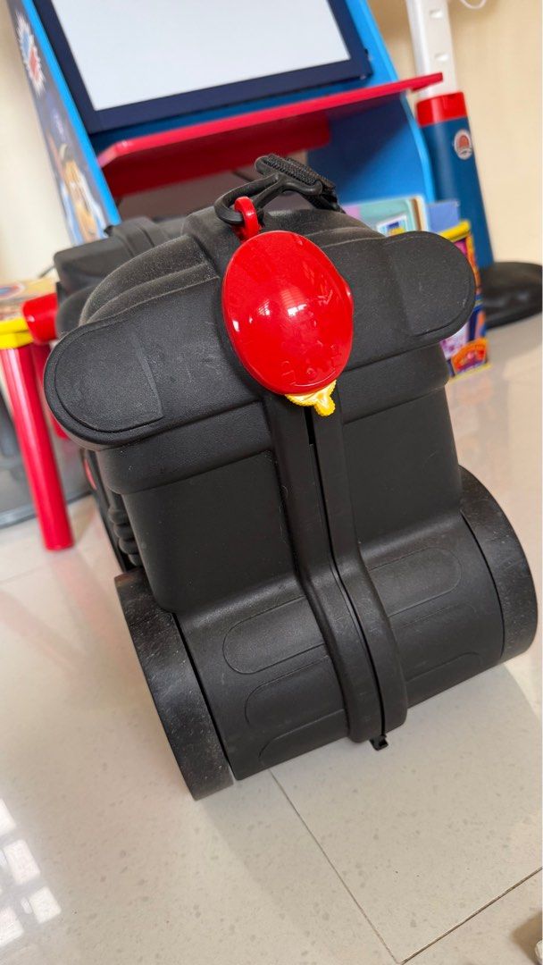 Ride-on Motorcycle Suitcase Luggage (Category: Luggage) located in Binan City. Submitted by gia.declutters (Listing ID 1420175384, Image 3). Description: - Motorcycle-style ride-on suitcase - Black with red wheel and accent design - Made of durable plastic - Features a handle for carrying - Opens up for storage - Fun and functional for kids RFS: outgrown no issues Perfect pang aliw sa airport.