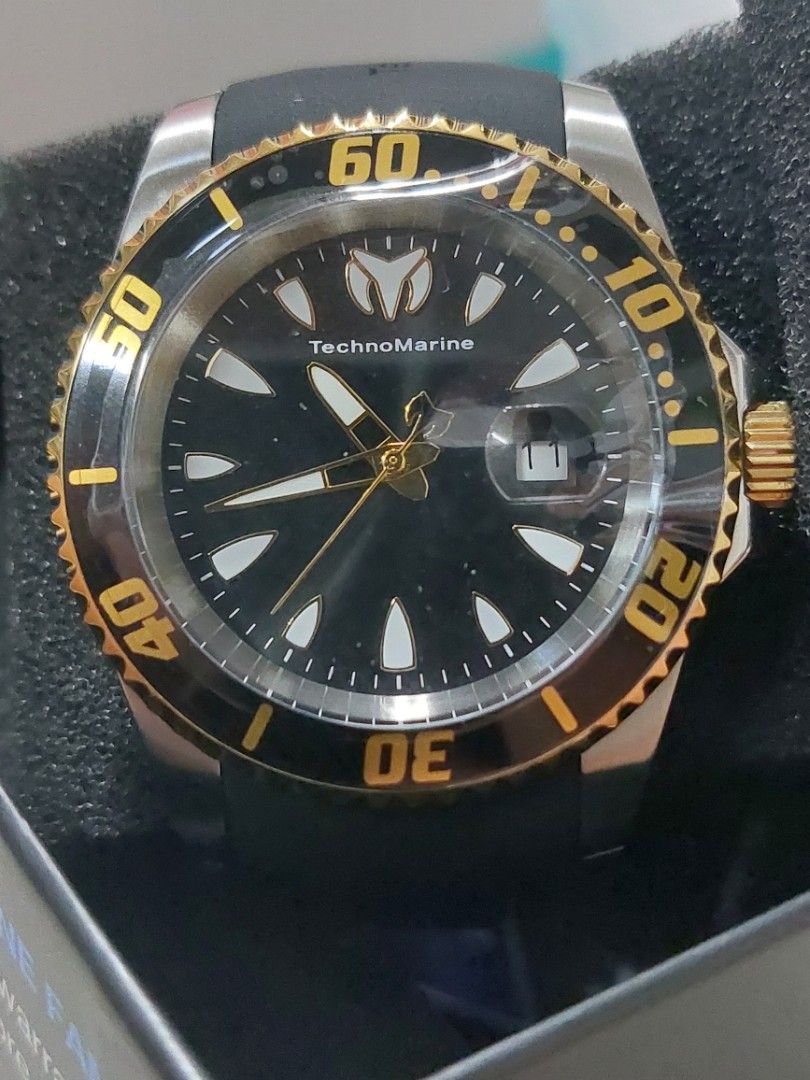 TechnoMarine Sea Manta Watch (Category: Men's Watches) located in Imus. Submitted by keenahsgiftshop (Listing ID 1420290135, Image 1). Description: - TechnoMarine Sea Manta watch - Black dial and gold-tone bezel - Black rubber strap with TechnoMarine logo - Date display - Water-resistant to 20ATM/650FT - Stainless steel back (Model: TM-220114) - Includes original box Techn0Marine Sea Manta Men's Silicone Strap ▪︎ 42mm, water resistant ▪︎ Caliber: