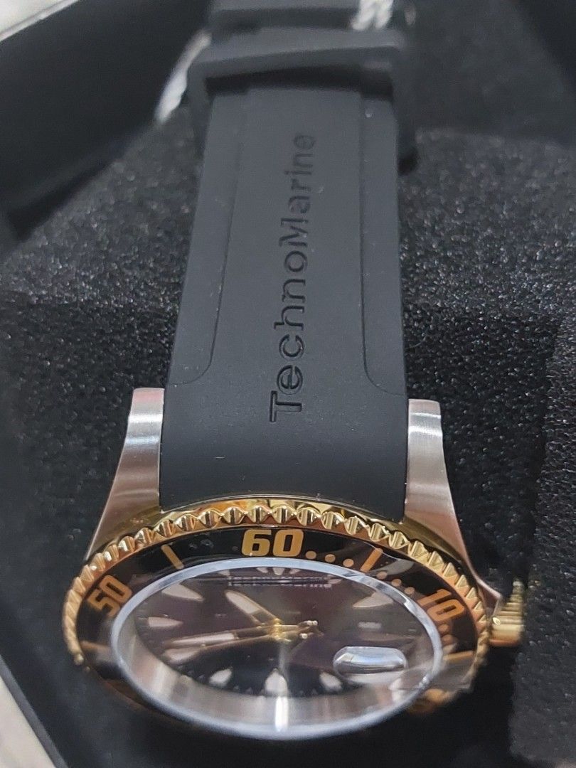 TechnoMarine Sea Manta Watch (Category: Men's Watches) located in Imus. Submitted by keenahsgiftshop (Listing ID 1420290135, Image 3). Description: - TechnoMarine Sea Manta watch - Black dial and gold-tone bezel - Black rubber strap with TechnoMarine logo - Date display - Water-resistant to 20ATM/650FT - Stainless steel back (Model: TM-220114) - Includes original box Techn0Marine Sea Manta Men's Silicone Strap ▪︎ 42mm, water resistant ▪︎ Caliber: