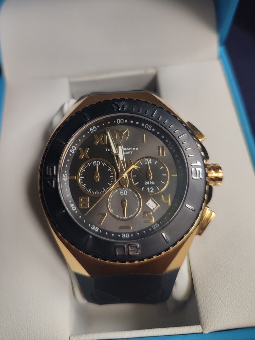 TechnoMarine TM-215066 Chronograph Watch (Category: Men's Watches) located in San Jose. Submitted by andreagarcia_ (Listing ID 1420220171, Image 3). Description: - TechnoMarine chronograph watch - Black and gold-tone design - Black bezel with gold accents - Black rubber strap - Gold-tone case - Multiple sub-dials - Date display - TechnoMarine logo and model information on the back - Comes with original box and warranty card 5,500 + lsf Never been