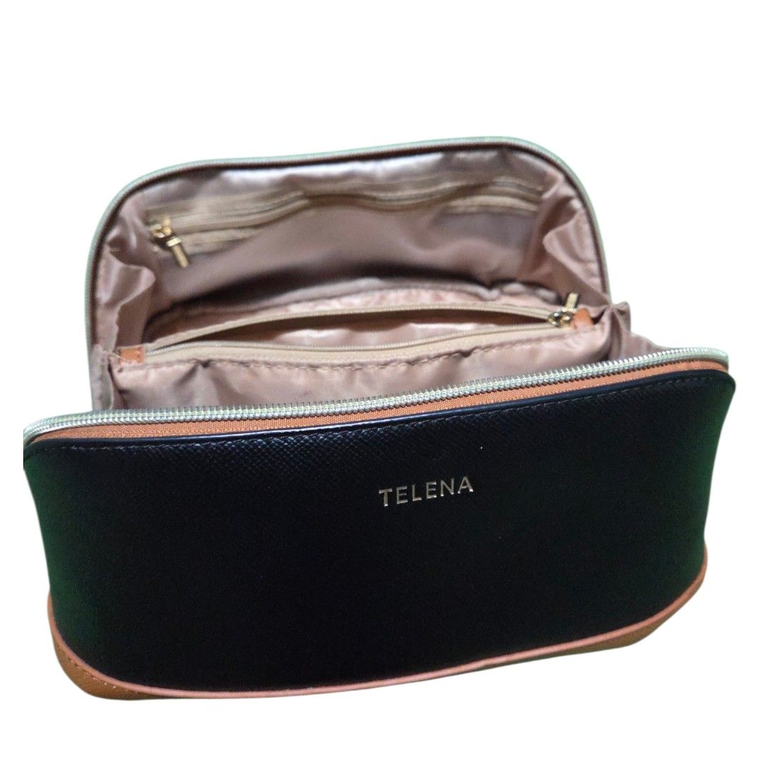 Telena Cosmetic Bag with Handle (Category: Purses & Pouches) located in Manila. Submitted by womensphstuff (Listing ID 1420280904, Image 3). Description: For sale: 500 Orig price: 3,000 - Telena cosmetic bag - Sleek black exterior with brown base and handle - Light beige interior - Multiple compartments for organization - Secure zipper closure - Easy to carry with handle.